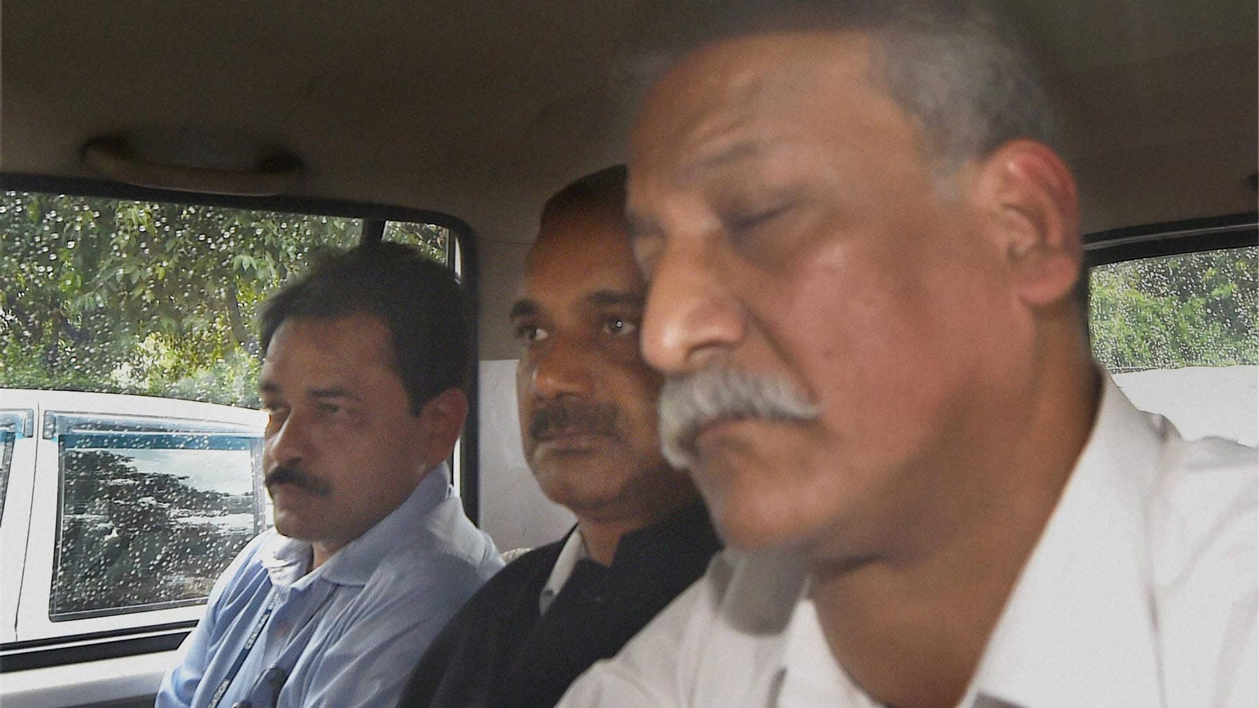CBI officials take away Delhi Chief Minister Arvind Kejriwal's Principal Secretary Rajendra Kumar (centre) after producing him at Patiala House court in a corruption case. (Photo: PTI)