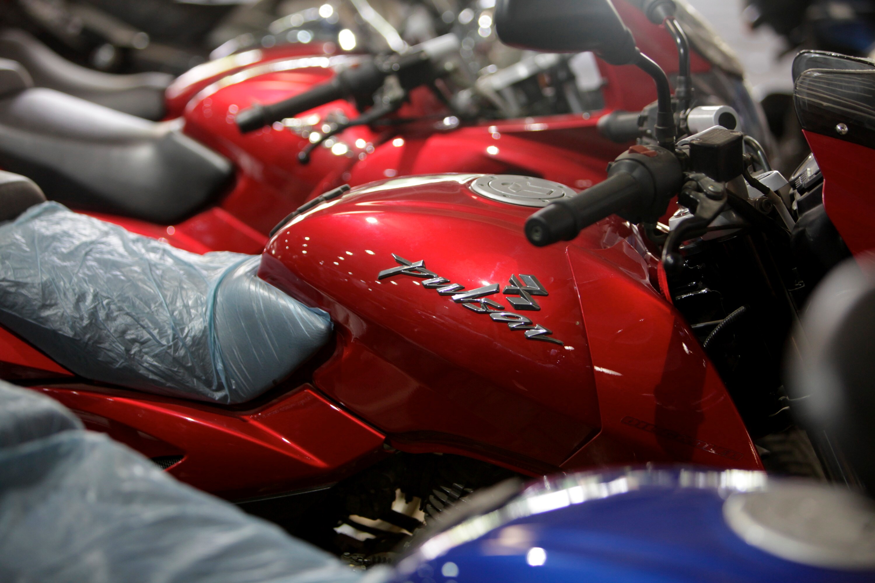 The Pulsar motorcycle, one of Bajaj Auto's bestselling vehicle, parked outside a company showroom in Mumbai, India (Photographer: Adeel Halim/Bloomberg)