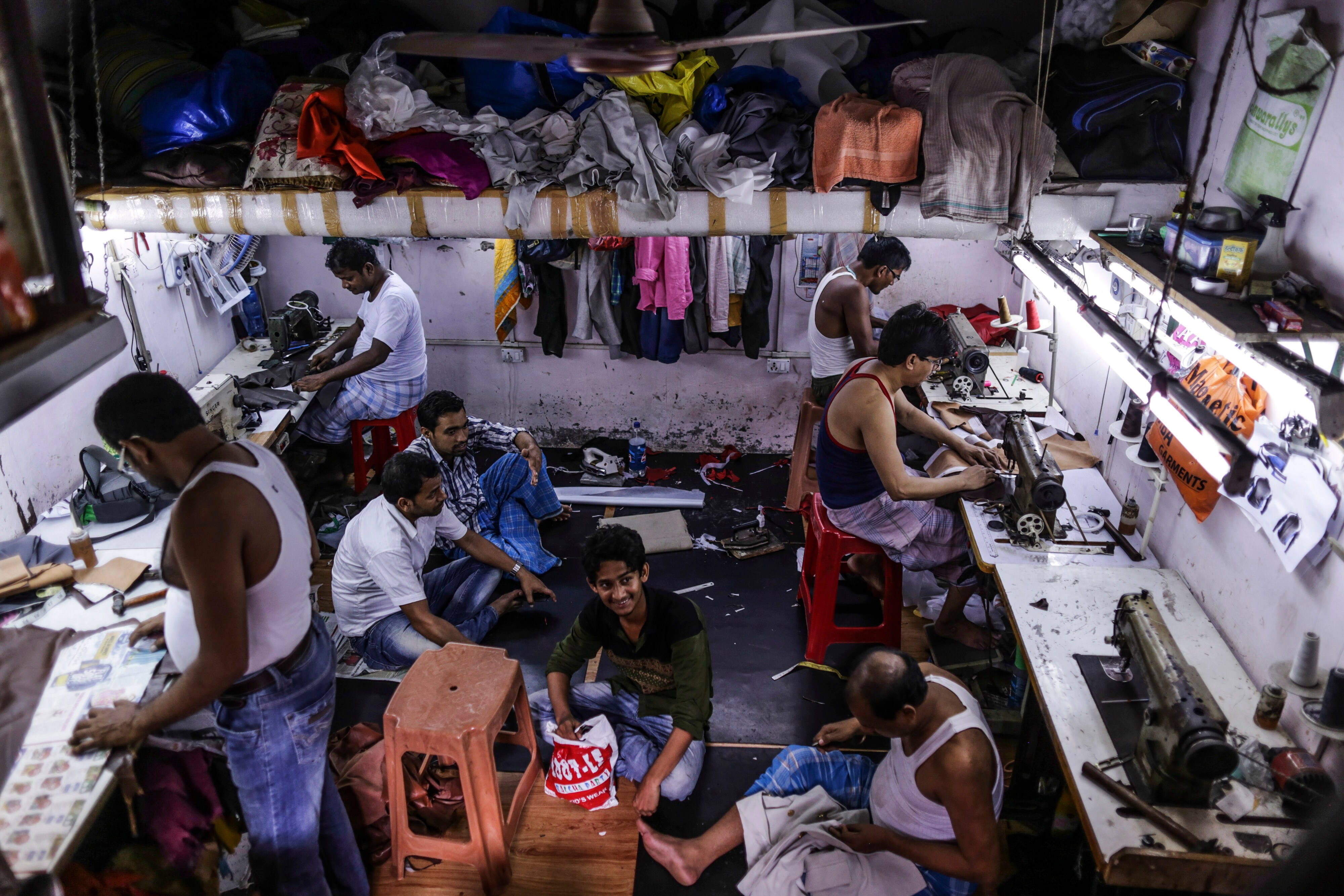 Workers Operate Sewing Machines at a Leather Workshop in Dharavi in Mumbai (Photographer: Dhiraj Singh/Bloomberg)