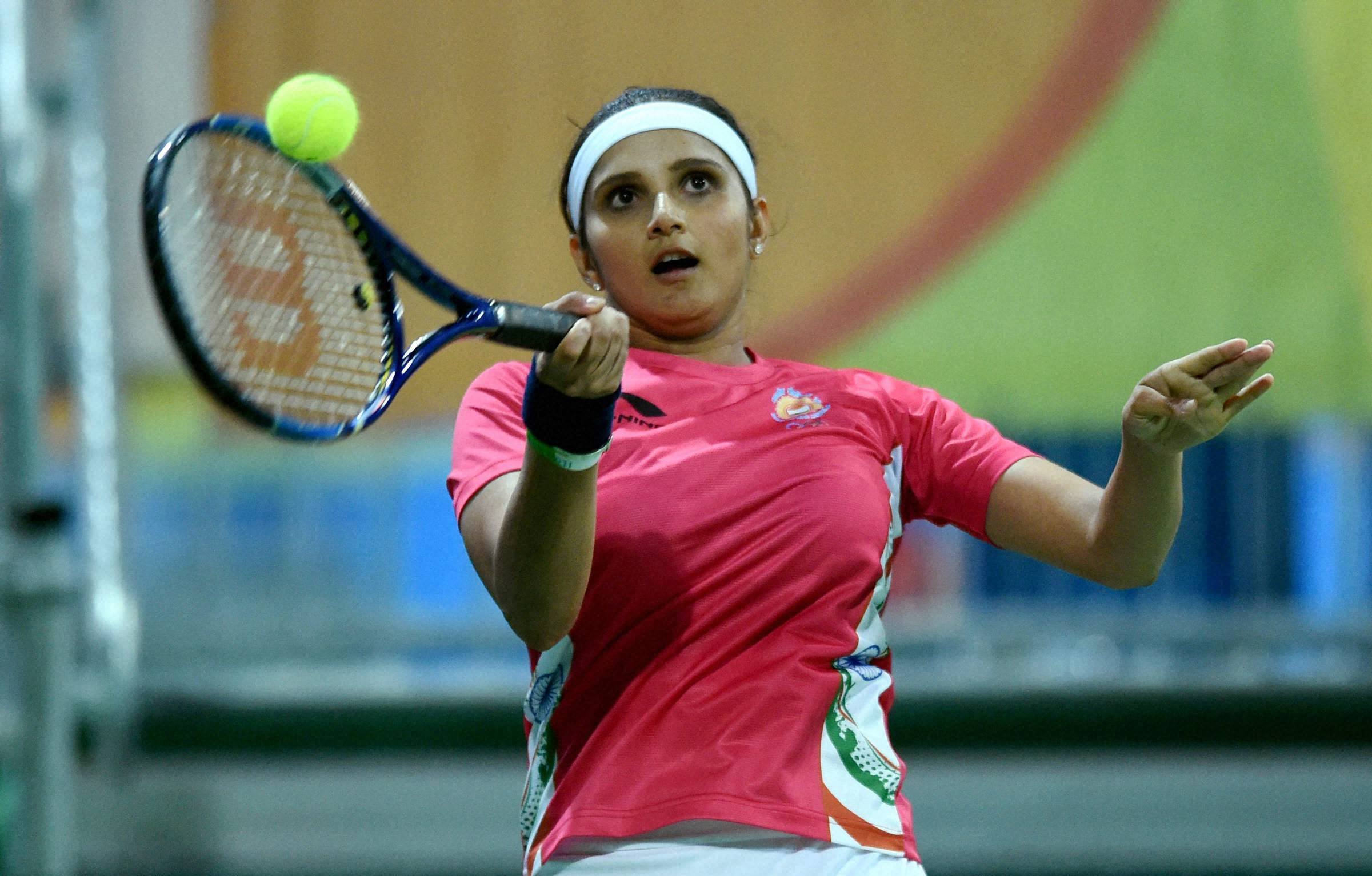 Sania Mirza plays a shot during a mix Doubles qualifying round with China. (Photographer: Atul Yadav/ PTI)