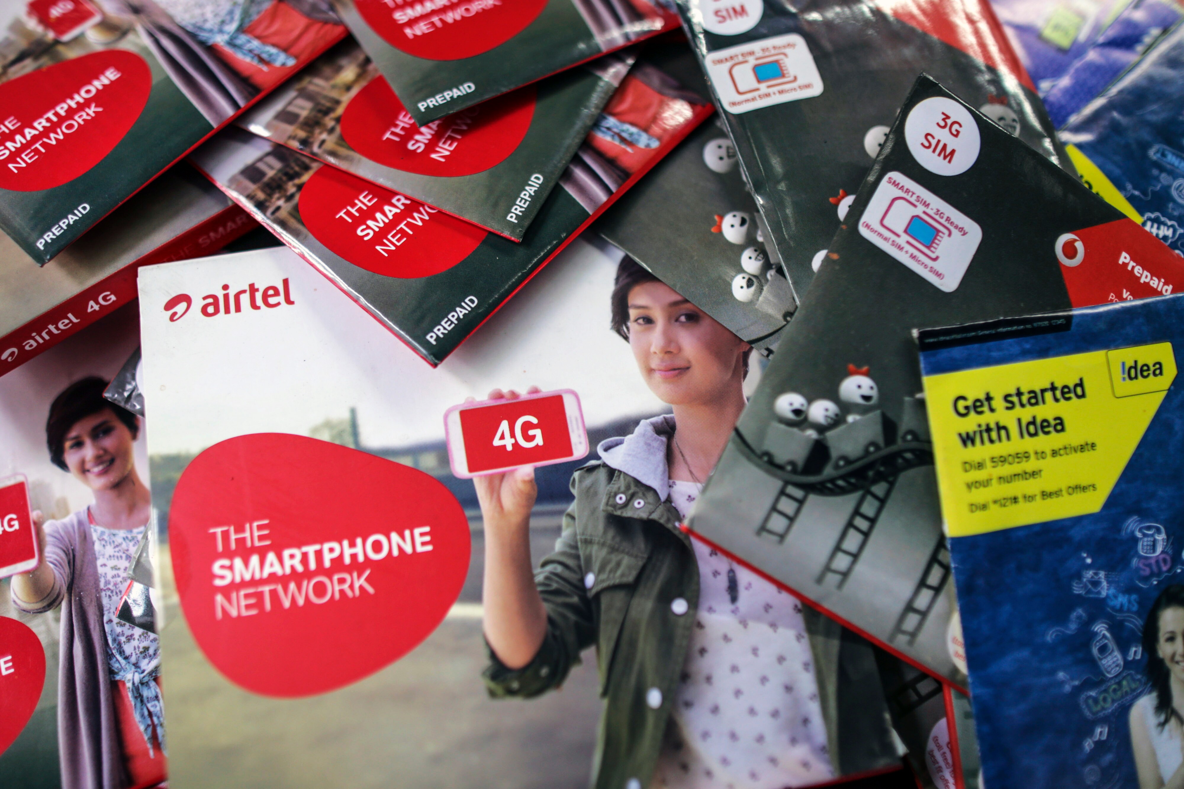 Bharti Airtel Ltd., Vodafone India Ltd. and Idea Cellular Ltd. sim card packs. (Photographer: Dhiraj Singh/Bloomberg)