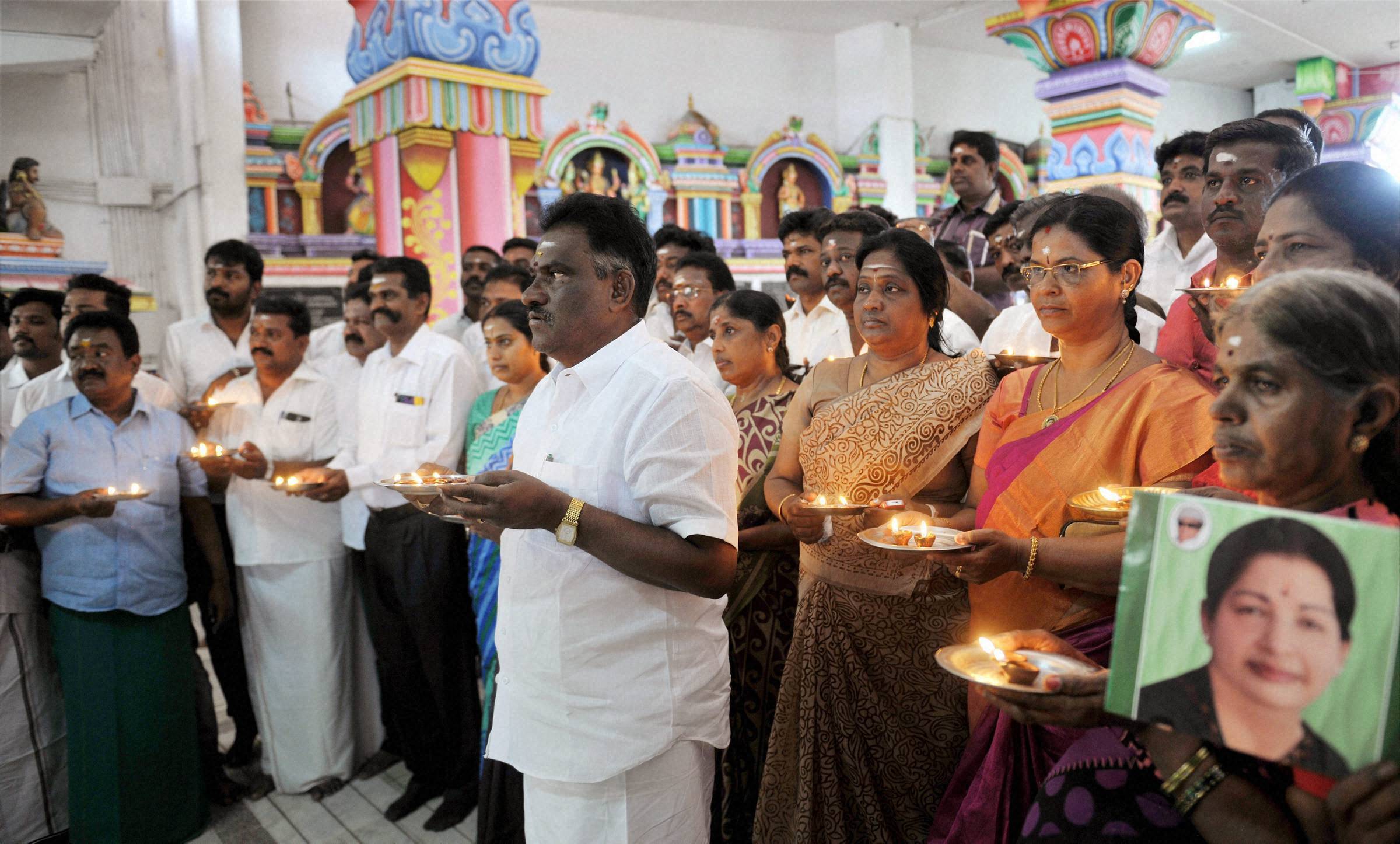 AIADMK MLA Amman Arjunan along with party members offer prayers for speedy recovery of Jayalalithaa. (Photo: PTI)