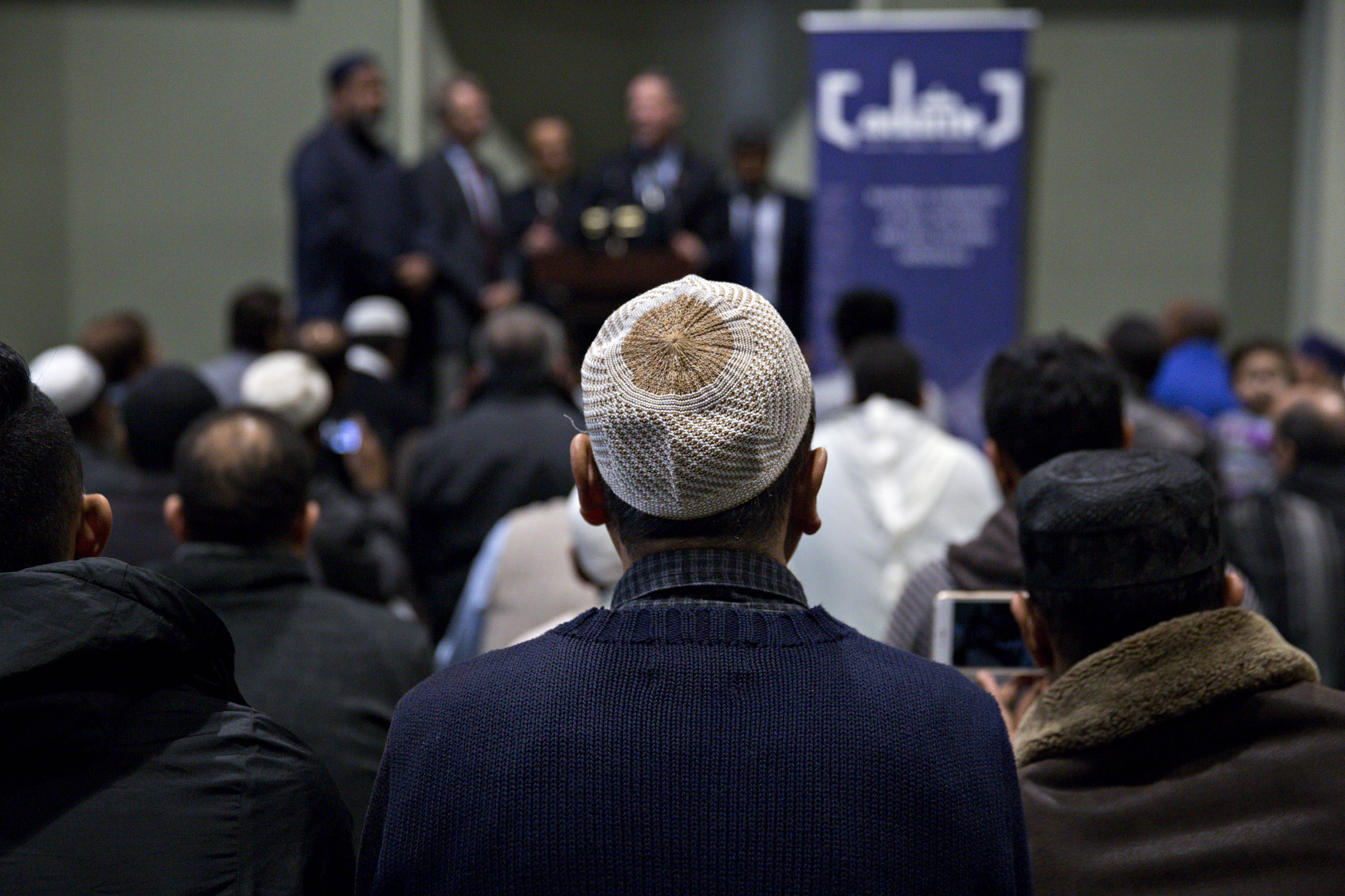 A congregant listens as Martin O'Malley, former governor of Maryland (top center) speaks with Imam Mohamed Magid (left). (Photographer: Andrew Harrer/Bloomberg)