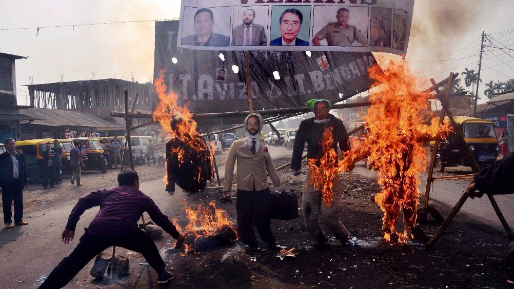 Protesters burn effigy of Nagaland Chief Minister TR Zeliang, Nagaland Home Minister Y Patton, NPF President Shürhozelie and Nagaland IRB personnel during a protest against killing of two youth by security personnel, in Dimapur, Nagaland. (Photo: PTI)