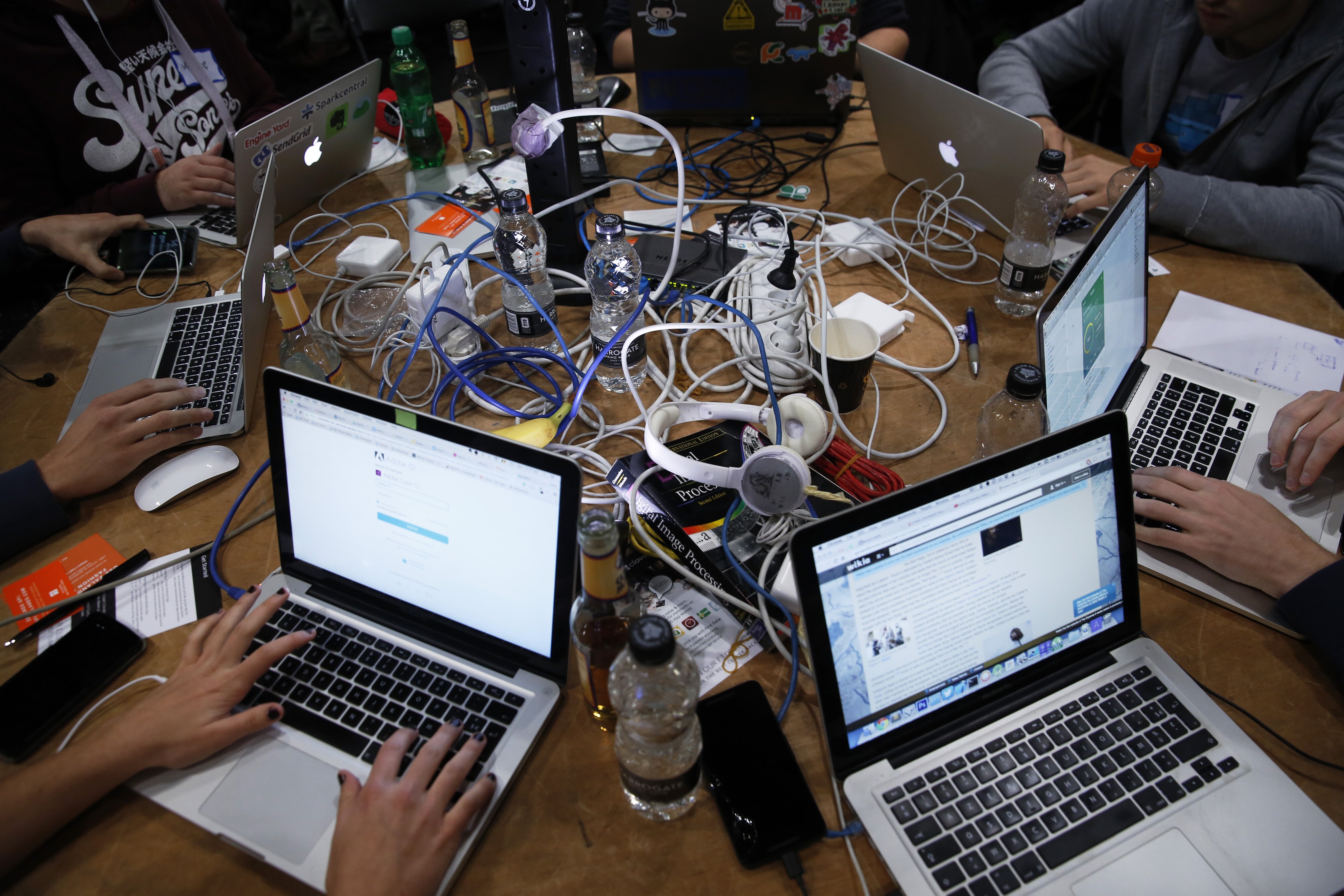 Attendees working on laptops at a hackathon in London, U.K. (Photographer: Luke MacGregor/Bloomberg)