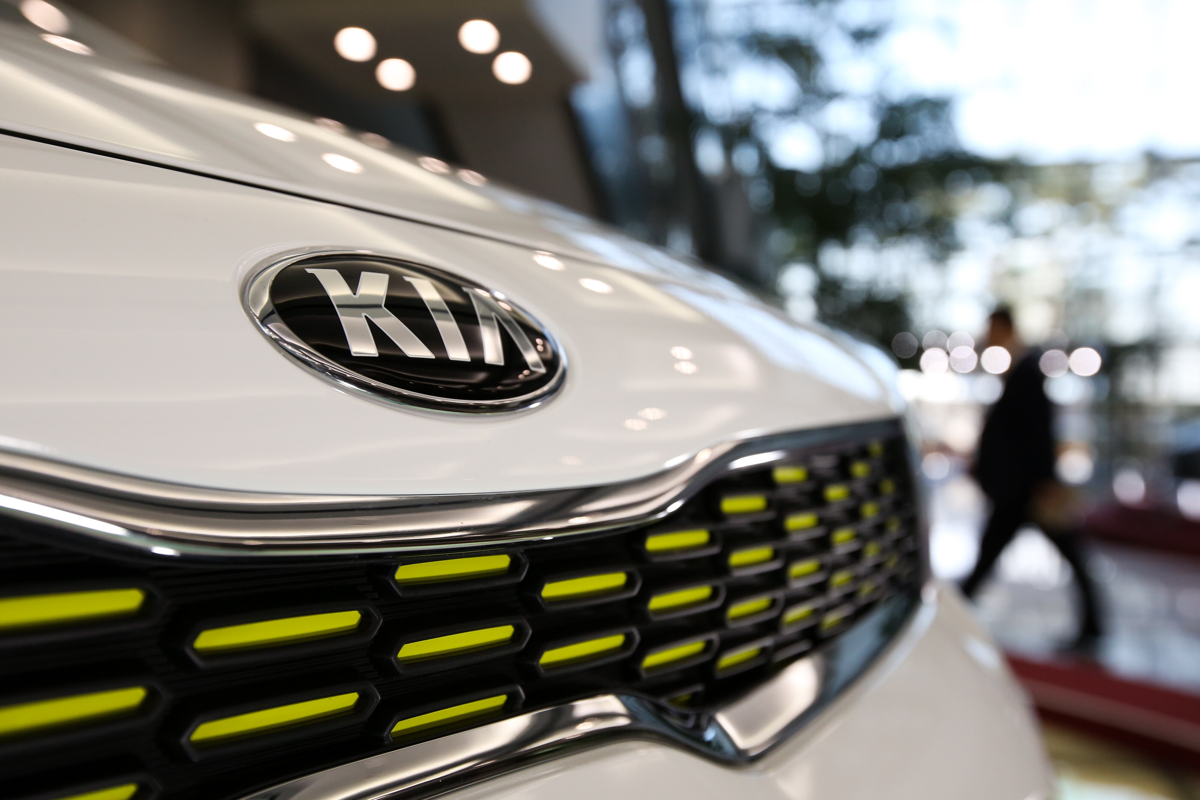 The Kia Motors Corp. logo is displayed on a vehicle in the lobby of the company's headquarters in Seoul, South Korea. (Photographer: SeongJoon Cho/Bloomberg)