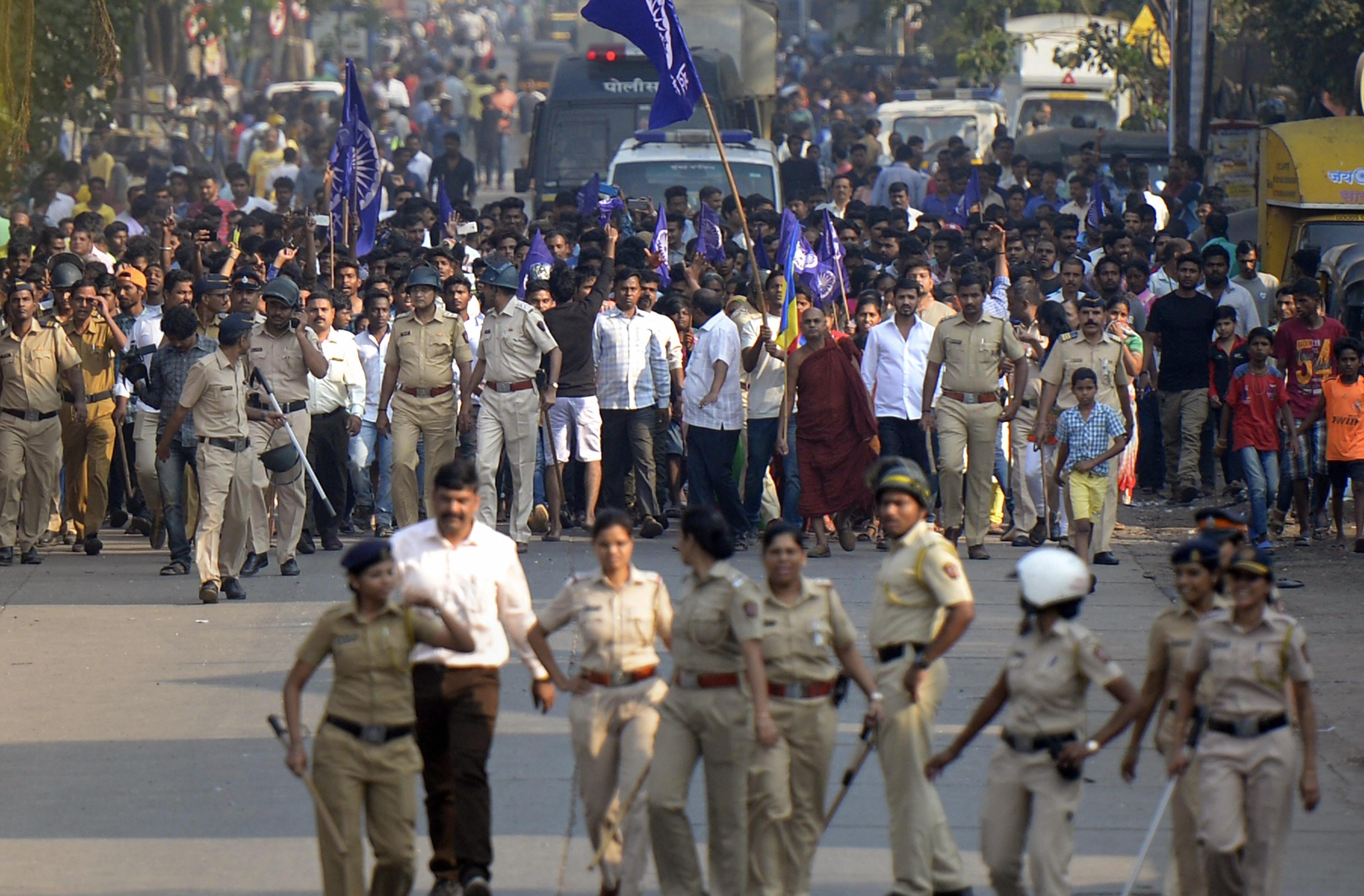 Policemen accompany the Dalits protestors as they stage a protest against the violence in Bhima Koregaon area of Pune, in Mumbai on Tuesday. (Image: PTI)