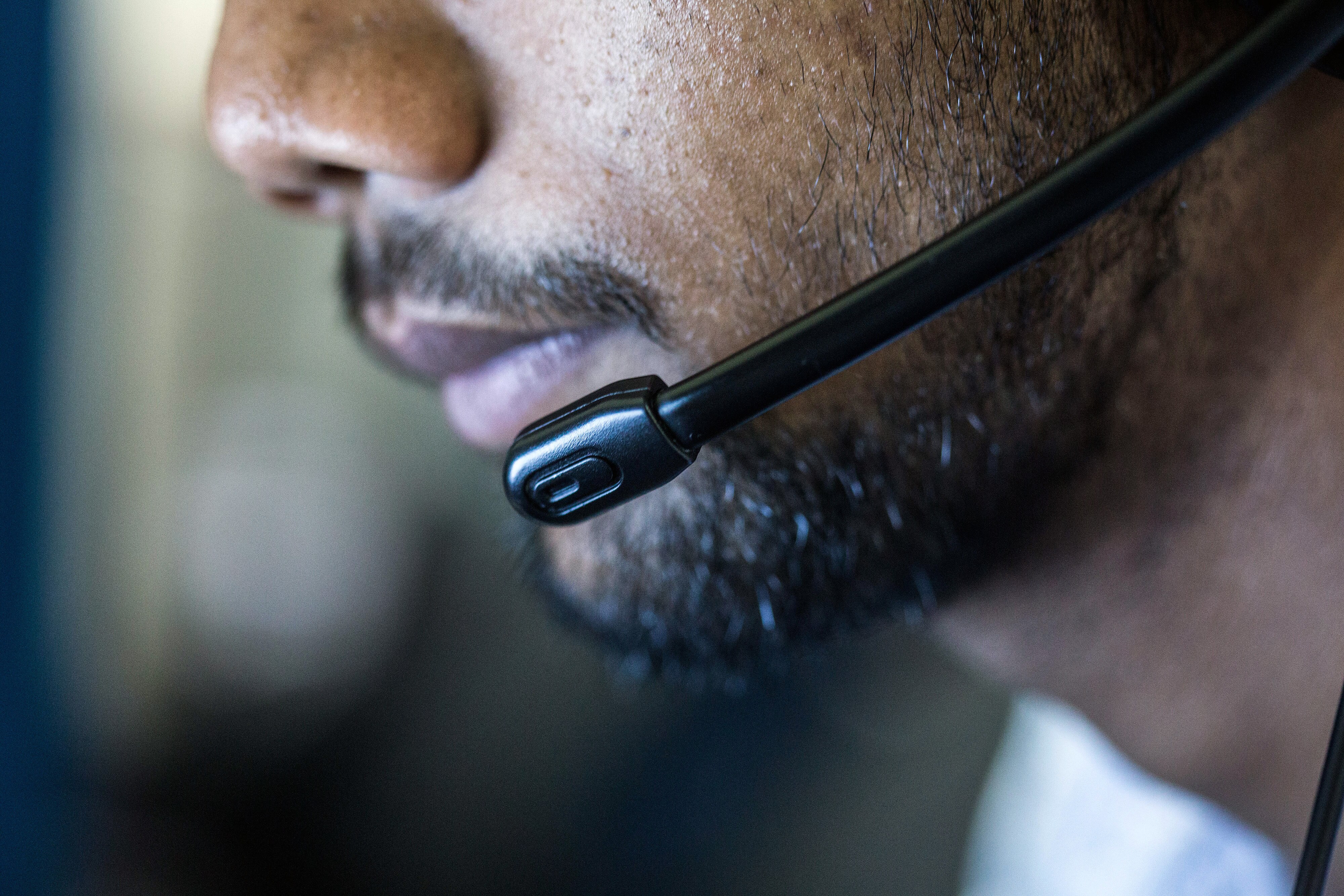 An employee wears a headset while working at the Avise Techno Solutions LLP call center in Kolkata. (Photograph: Taylor Weidman/Bloomberg)