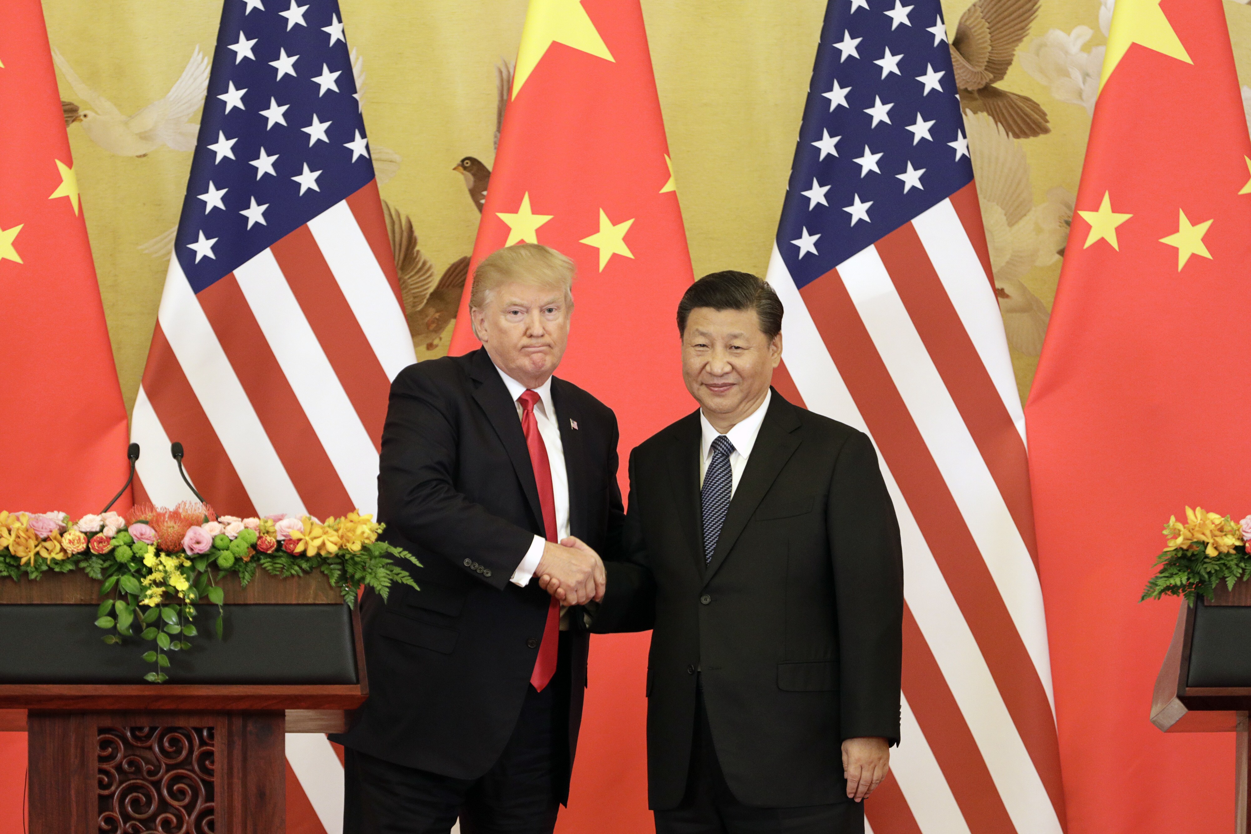FILE: U.S. President Donald Trump, left, and Xi Jinping, China's president, shake hands during a news conference in Beijing, China, on Nov. 9, 2017. (Photographer: Qilai Shen/Bloomberg)