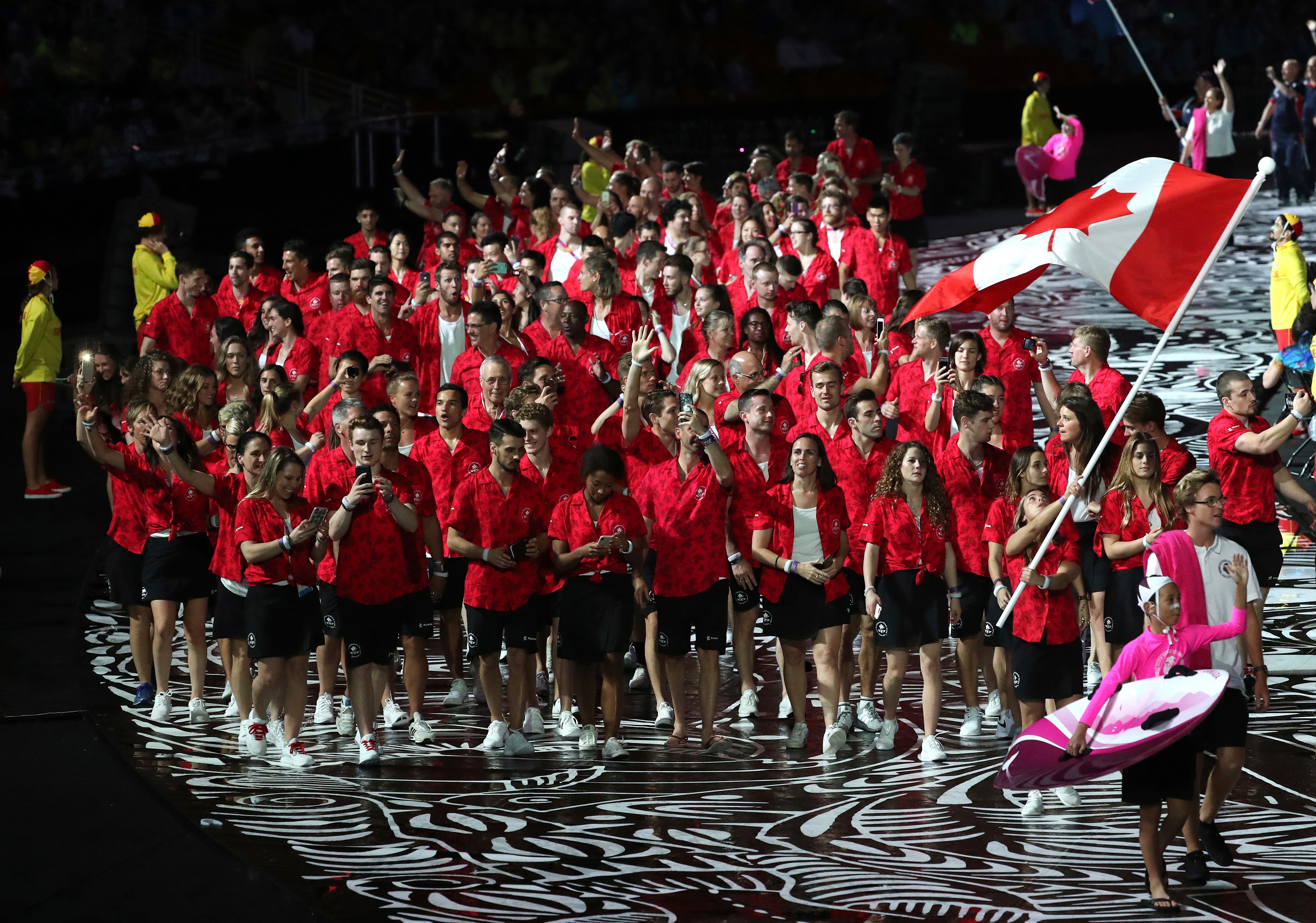 Canada flag-bearer Meaghan Benfeito leads her team into Carrara Stadium for the opening ceremony of the 2018 Commonwealth Games.