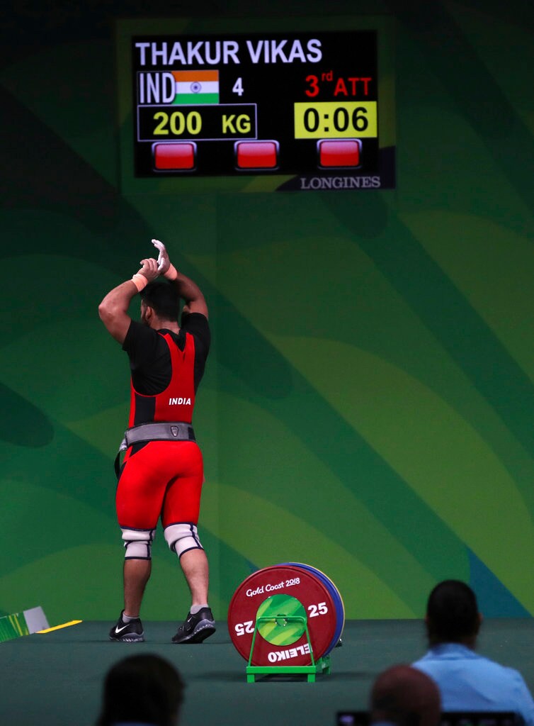 Vikas Thakur reacts after failing to lift 200 kg in his third attempt in the clean and jerk round.
