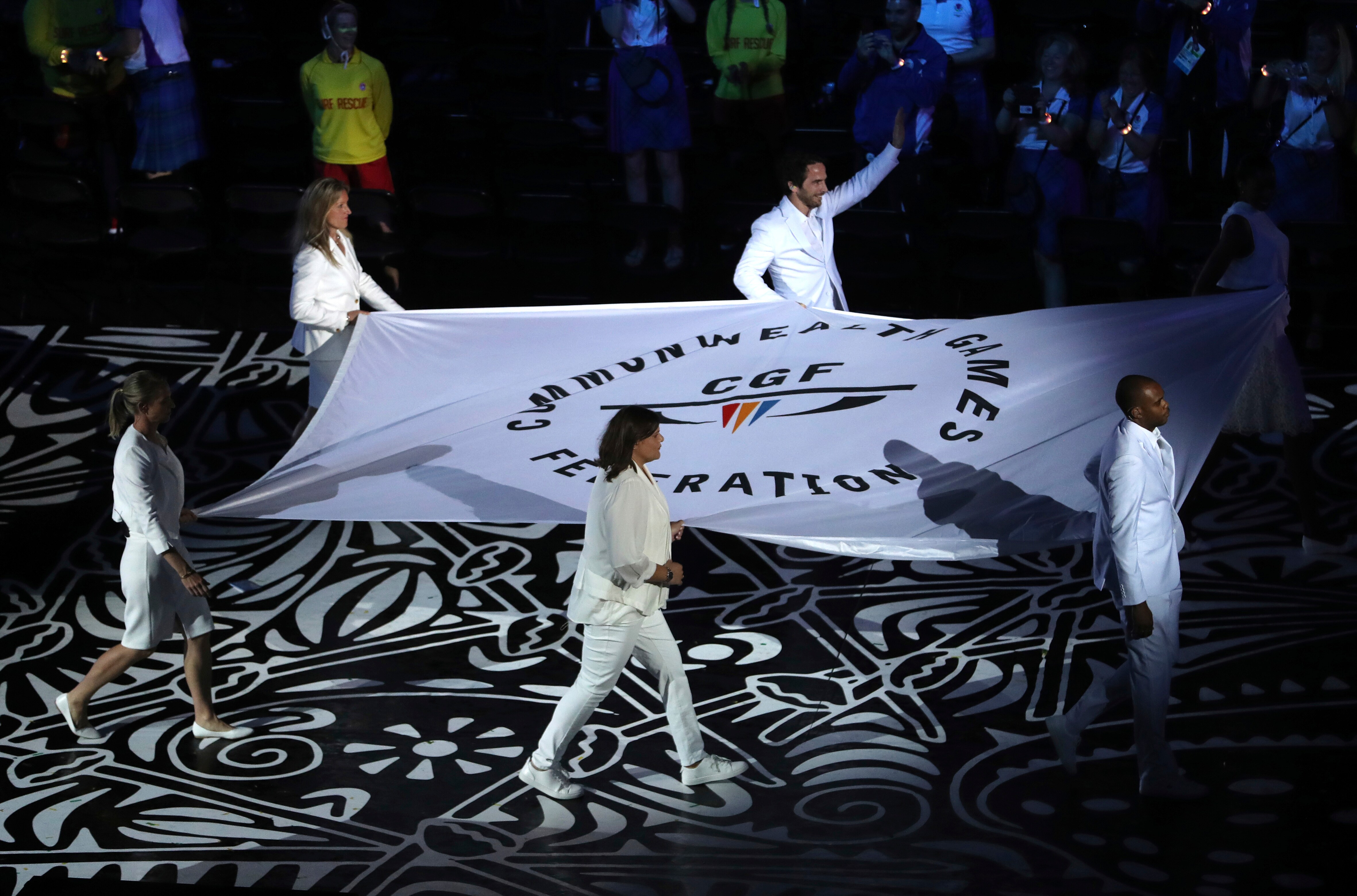 The Commonwealth Games flag is carried into Carrara Stadium for the opening ceremony for the 2018 Commonwealth Games.