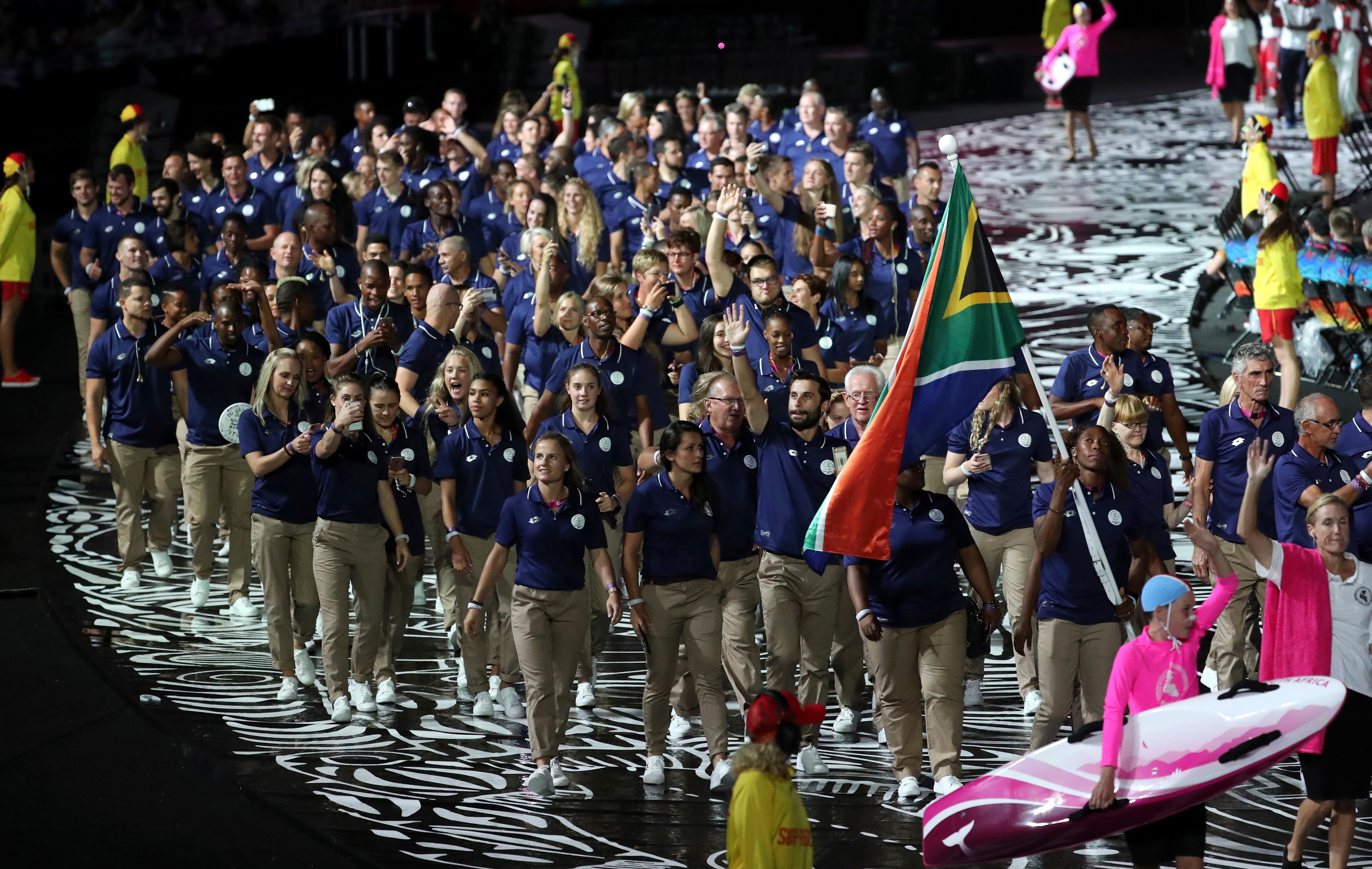 South Africa's flag-bearer Caster Semenya leads her team into Carrara Stadium for the opening ceremony.