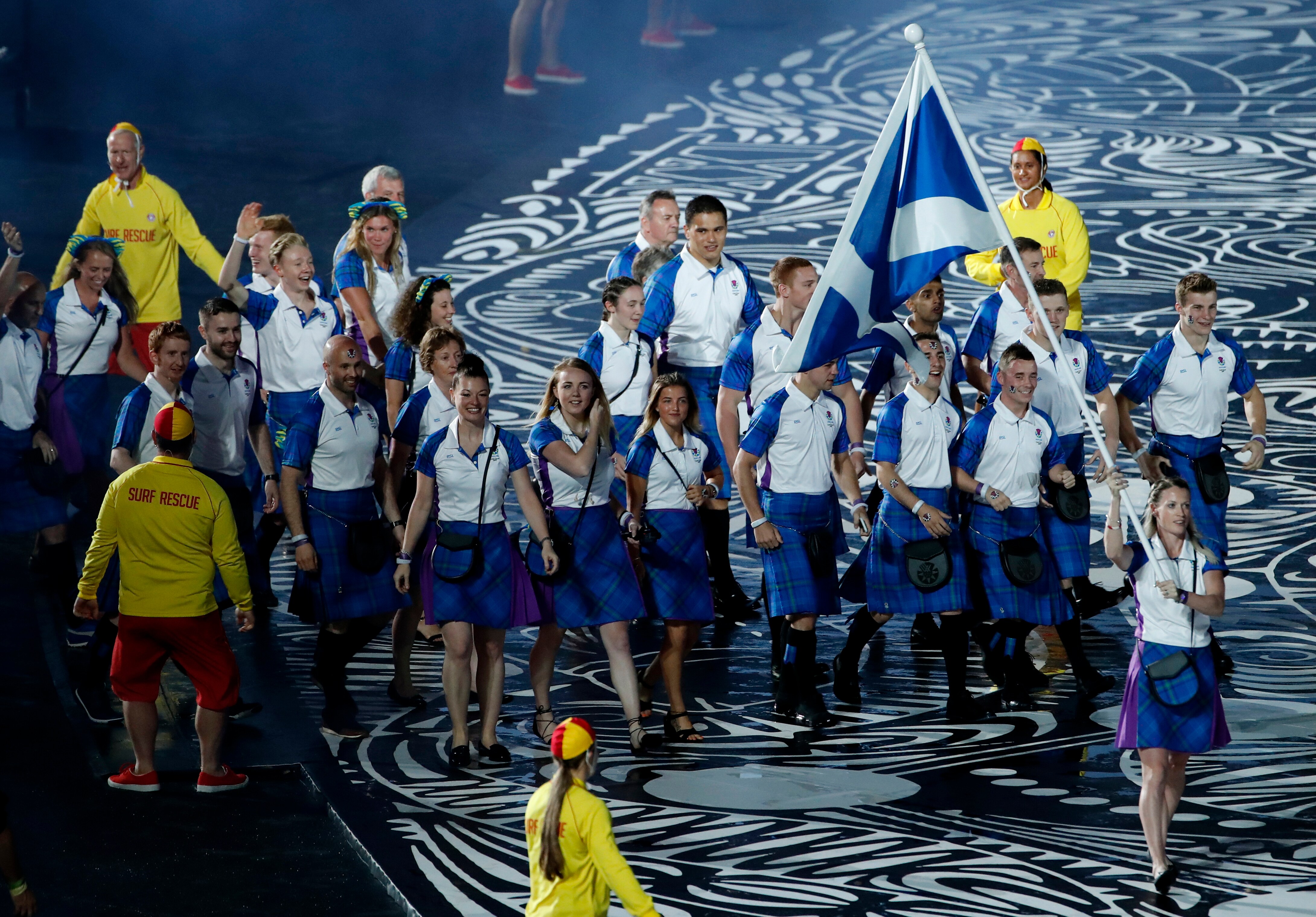 Team Scotland flag-bearer Eilidh Doyle leads her team into Carrara Stadium.