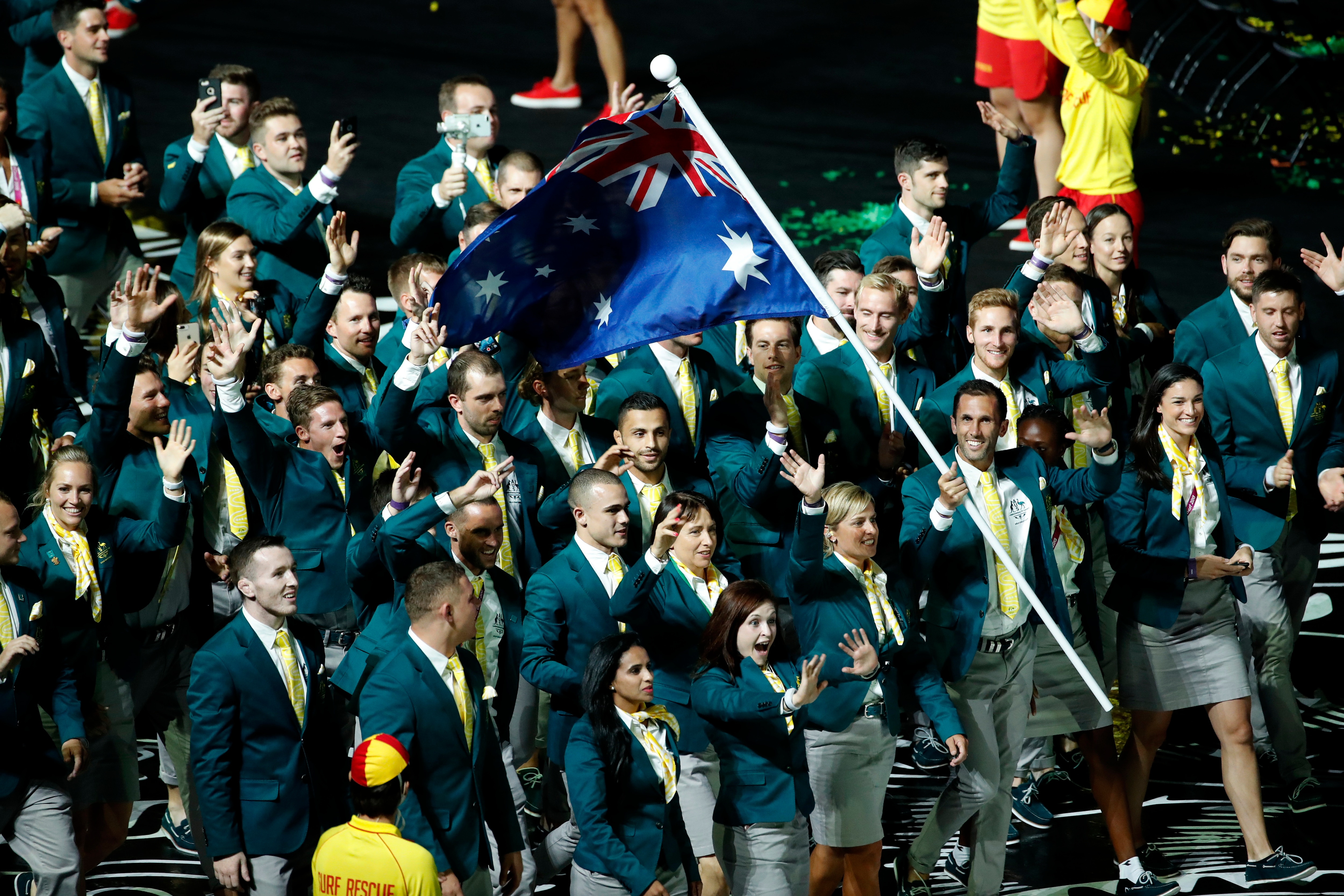 Team Australia is led by flag bearer Mark Knowles at Carrara Stadium at the opening ceremony for the 2018 Commonwealth Games.