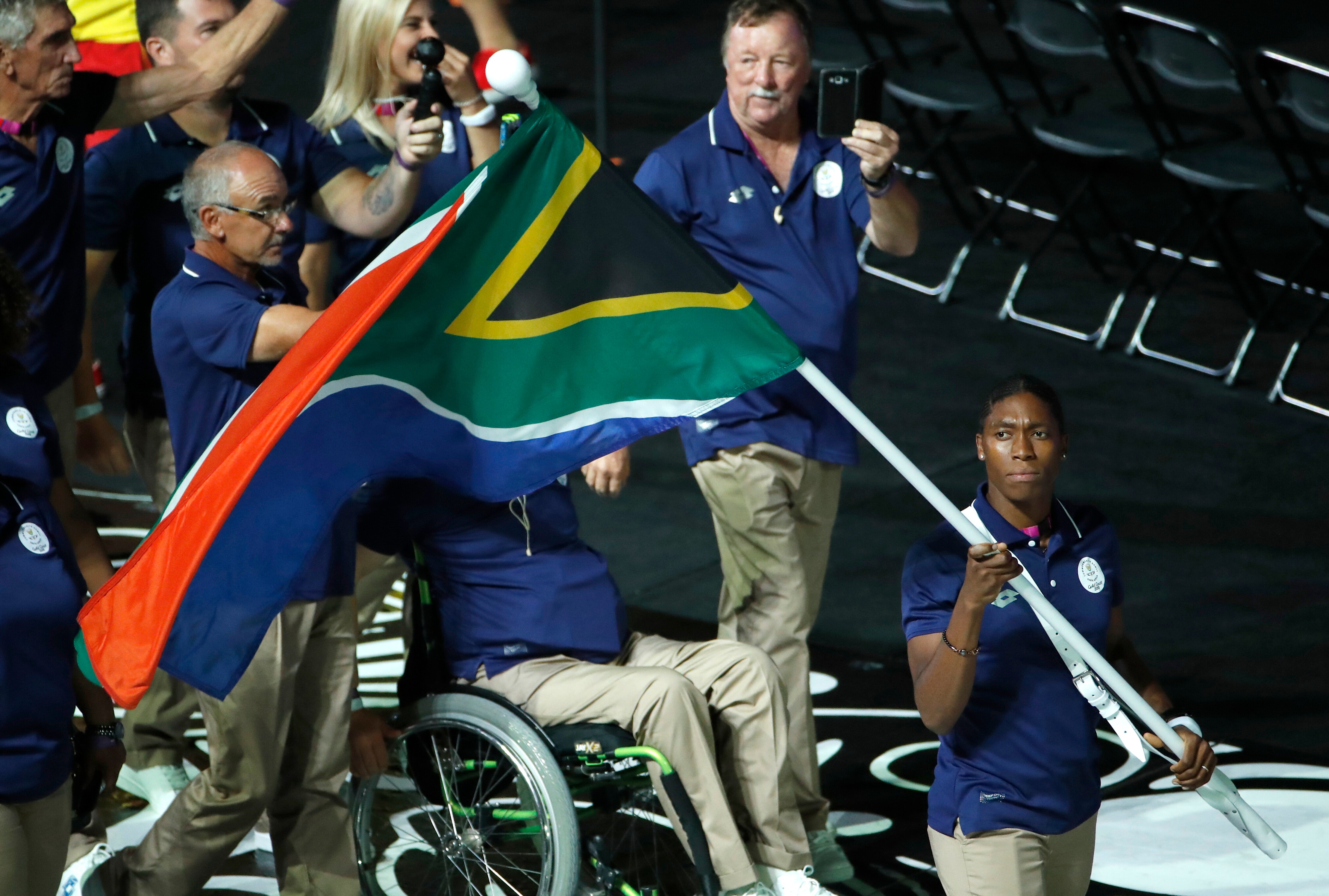 South Africa's flag-bearer Caster Semenya leads her team into Carrara Stadium for the opening ceremony.