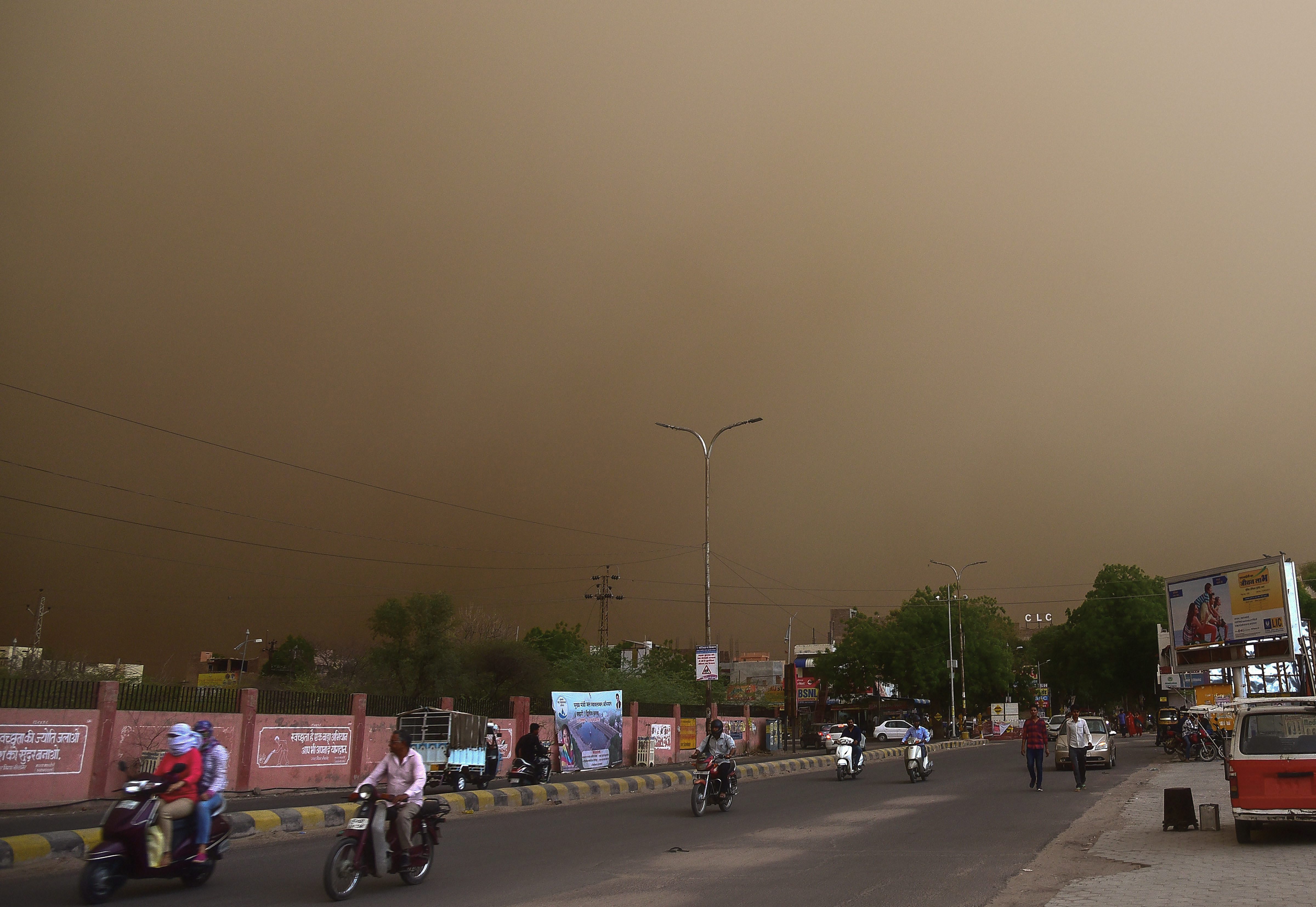 Vehicle ride past on a road during a dust storm in Bikaner (Source: PTI)