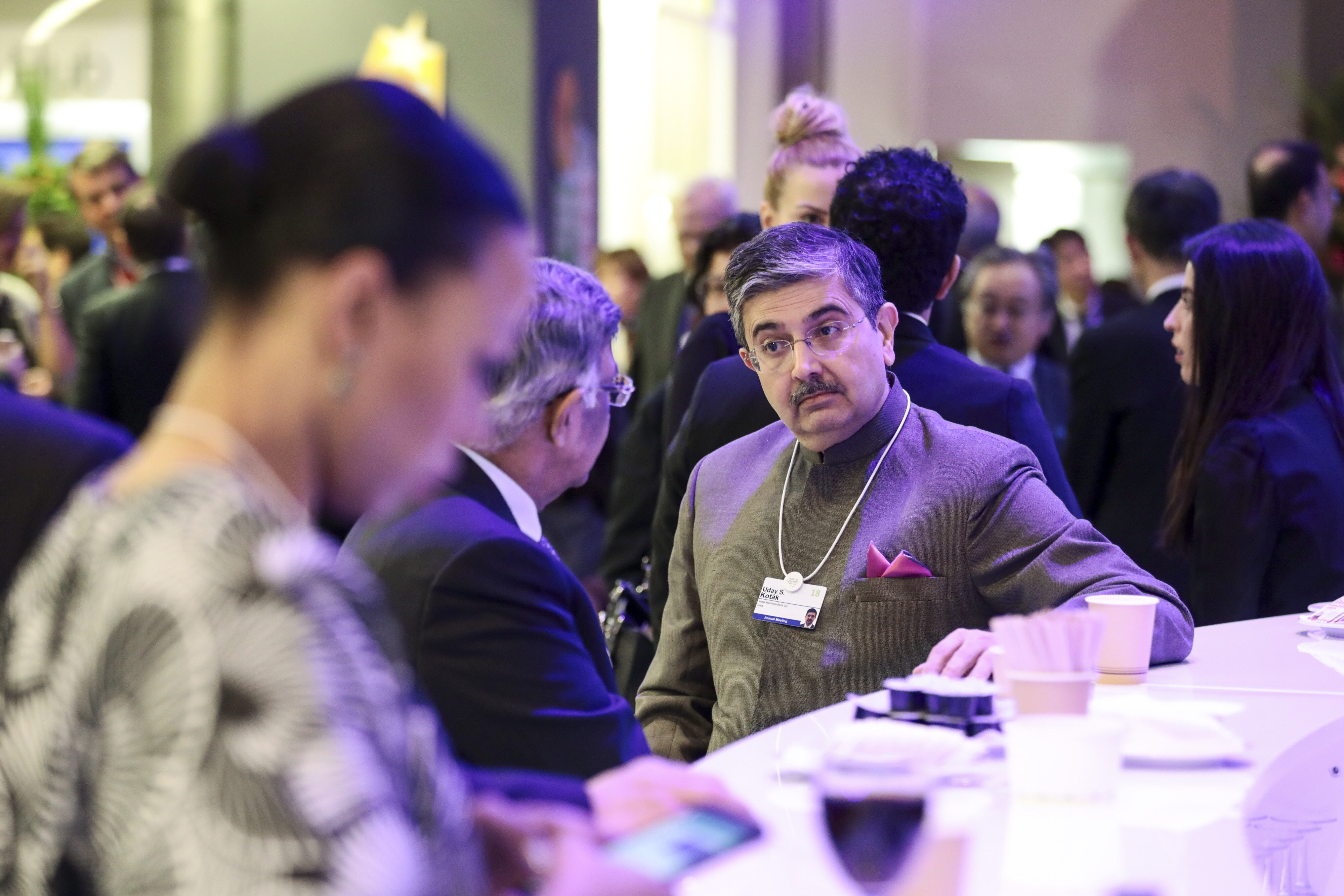 Uday Kotak, vice chairman of Kotak Mahindra Bank, center right, speaks to Baba Kalyani, chairman of Bharat Forge, ahead of the World Economic Forum in Davos, Switzerland, on Jan. 22, 2018. (Photographer: Simon Dawson/Bloomberg)