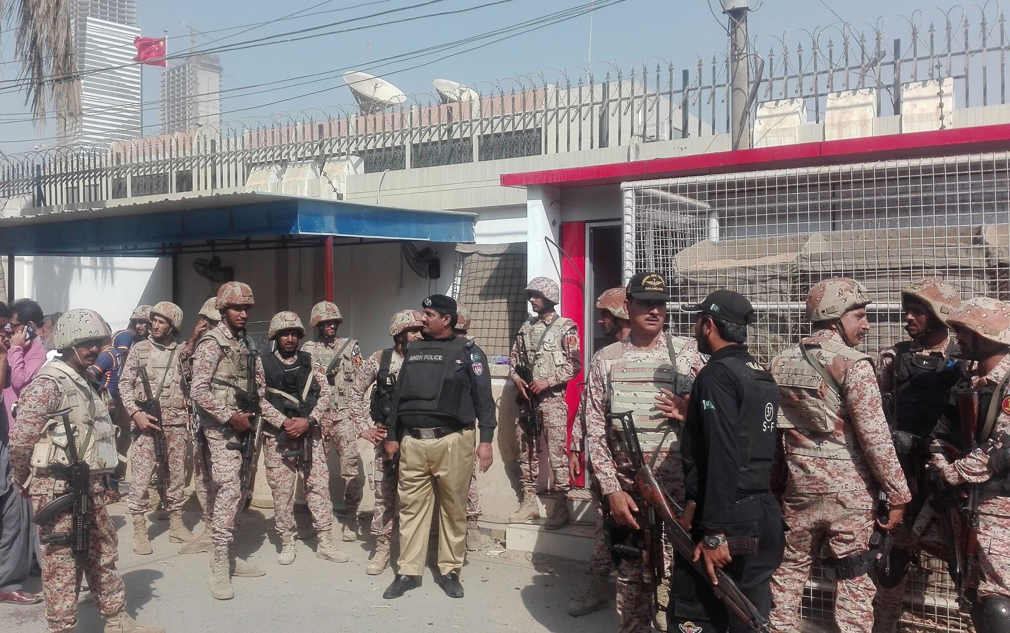 Pakistani security personnel stand outside the Chinese consulate after an attack in Karachi on Nov. 23.Photographer: Asif Hassan/AFP via Getty Images