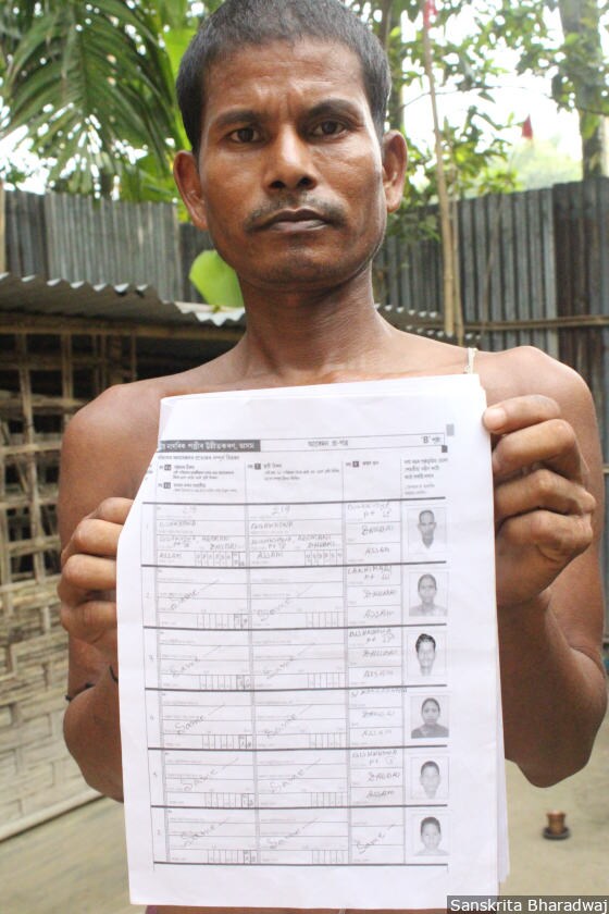 Mahendra Barman holds up his family's NRC application form.