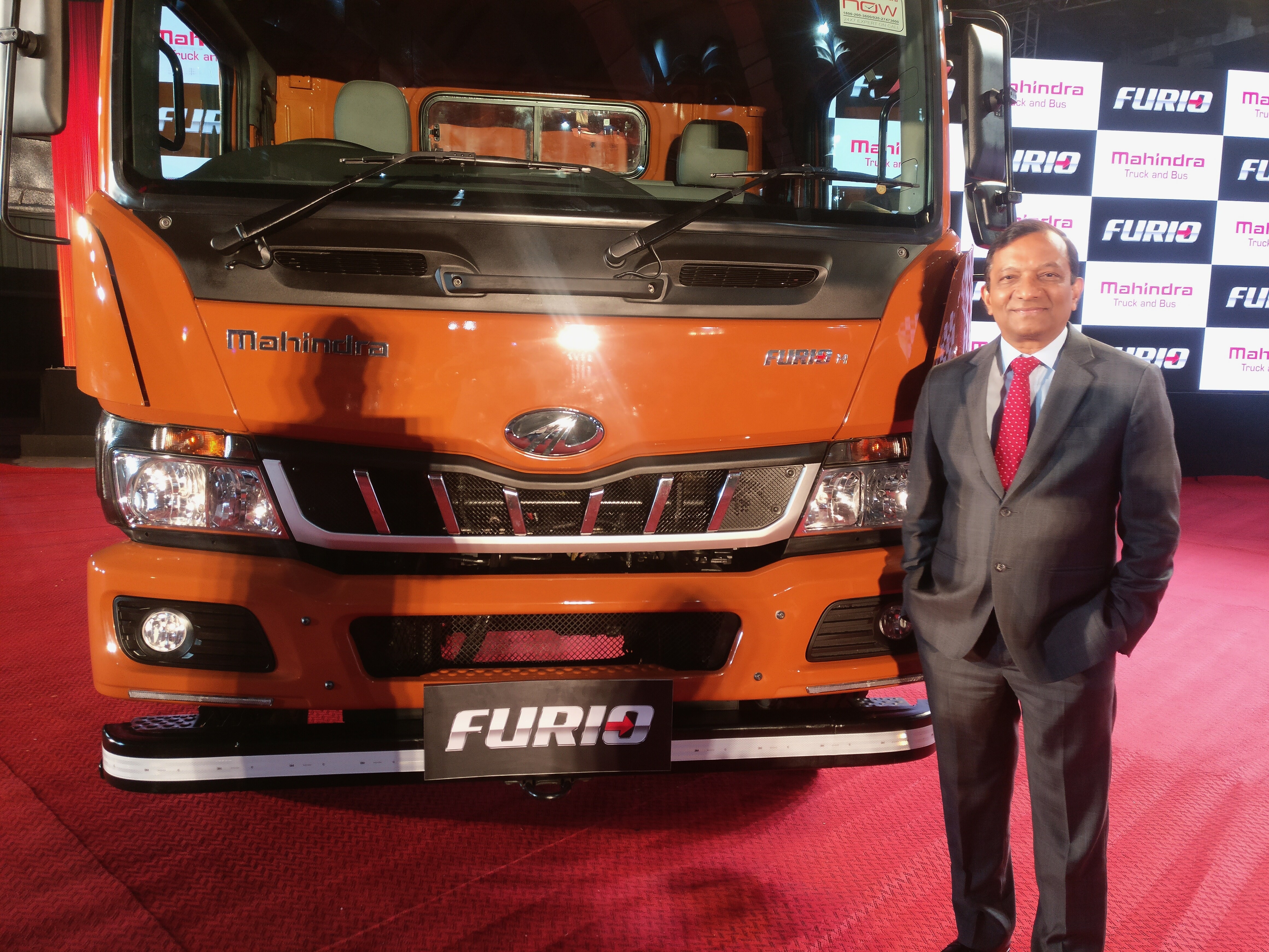 Pawan Goenka, managing director at Mahindra & Mahindra Ltd. poses with a Mahindra Furio truck displayed at the launch conference held in Mumbai. (Source: BloombergQuint)