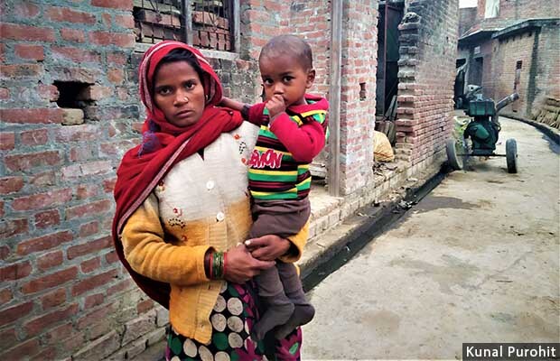 Satwati, whose husband Mukesh has been arrested on charges of lynching Shahrukh Khan, with her son, Naval. (Source: IndiaSpend)