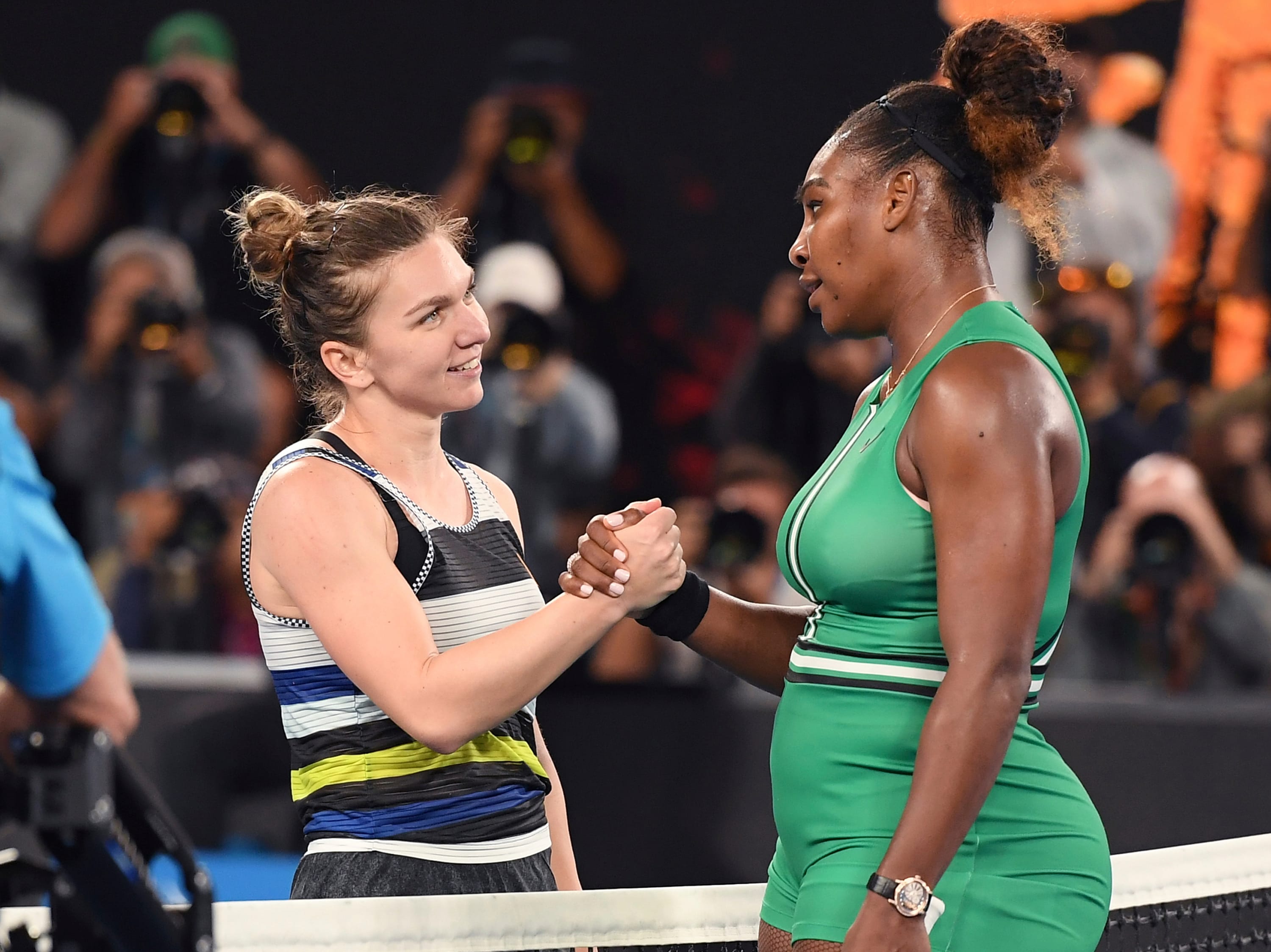 Serena Williams, right, is congratulated by Romania's Simona Halep after winning their fourth round match at the Australian Open tennis championships in Melbourne, Australia, Monday, Jan. 21, 2019.