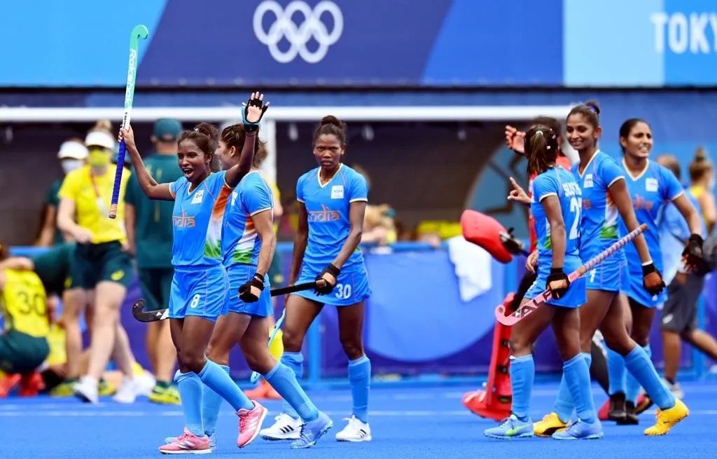 India defender Nikki Pradhan lifts her hockey stick to celebrate the quarterfinal win over Australia, at the Olympic Games, in Tokyo, on Aug. 2, 2021. (Photograph: Hockey India)
