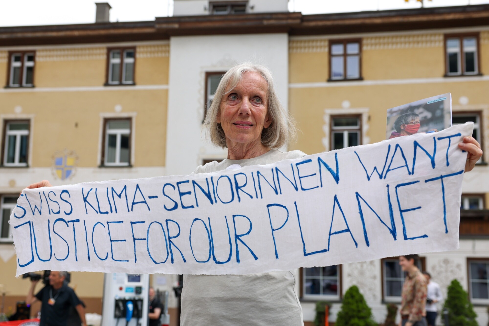 A protester against the World Economic Forum (WEF) holds a placard.Photographer: Hollie Adams/Bloomberg