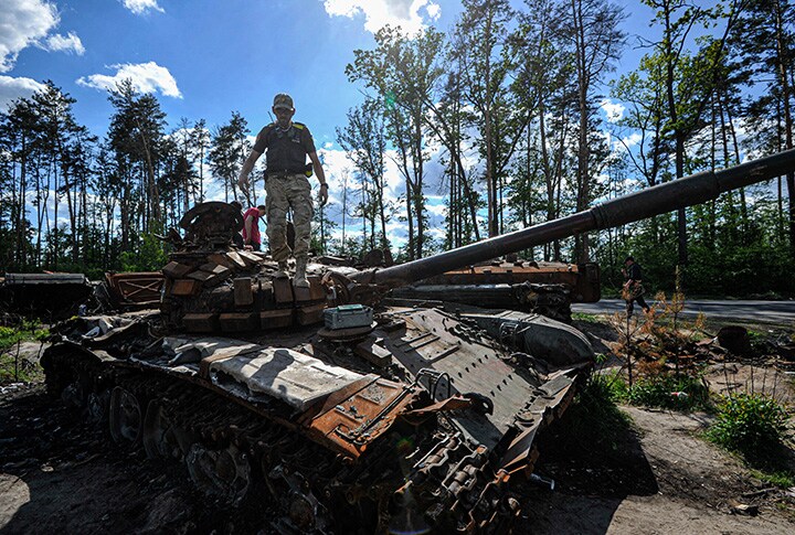 A man inspects a destroyed Russian tank in Dmytrivka village near Kyiv, Ukraine.Photographer: Sergei Chuzavkov/SOPA Images/LightRocket/Getty Images