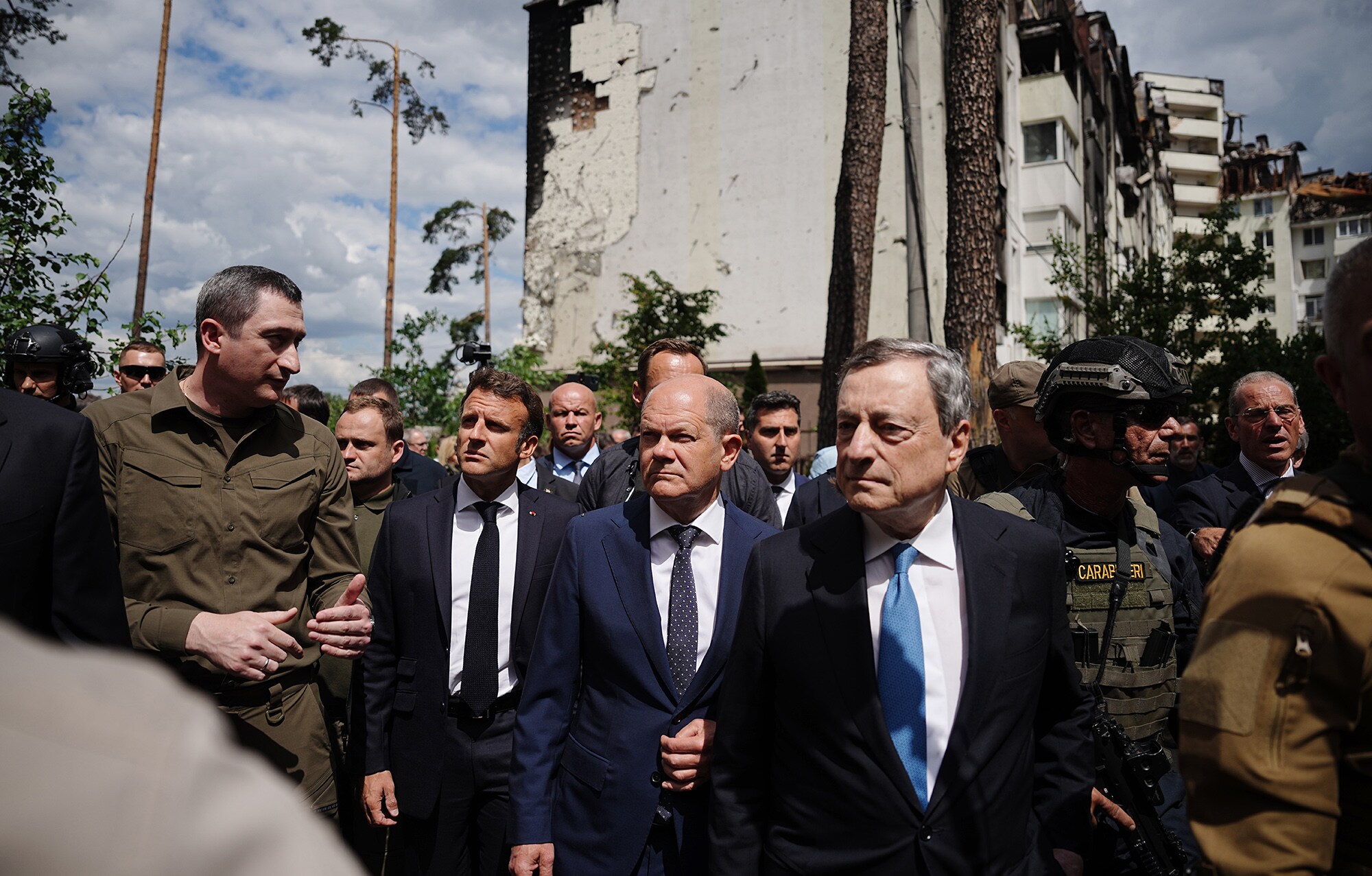 Oleksiy Chernyshov, left, the Ukrainian President's special envoy for an EU accession perspective, walks with Emmanuel Macron, Olaf Scholz, and Mario Draghi past destroyed buildings in Irpin, Ukraine on June 16.Photographer: Kat Nietfeld/dpa/picture alliance/Getty Images