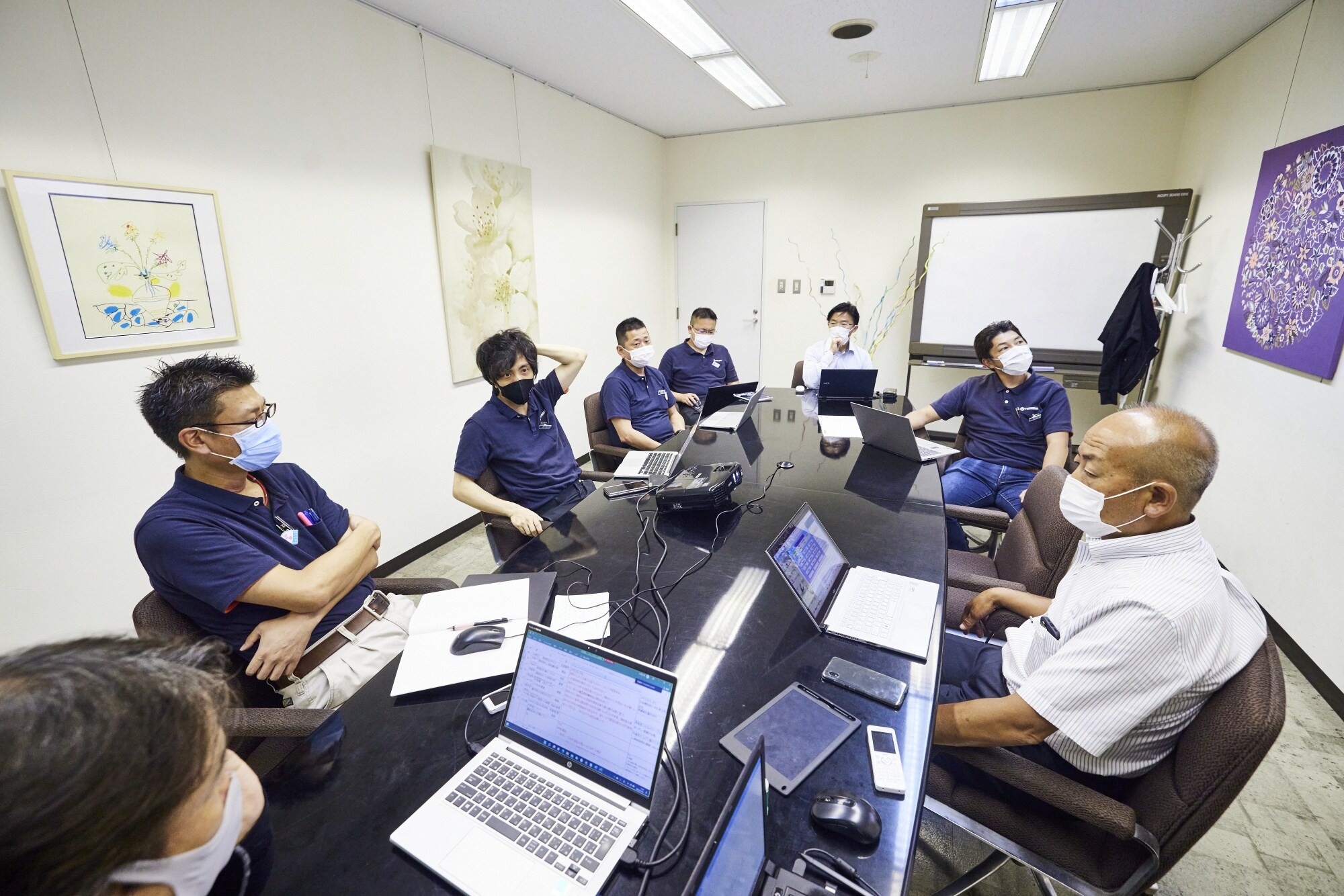Arai, second from left, during a management meeting at Toshima Manufacturing. NGTG has bought six companies and plans to buy three to five more in two years. Photographer: Shoko Takayasu/Bloomberg