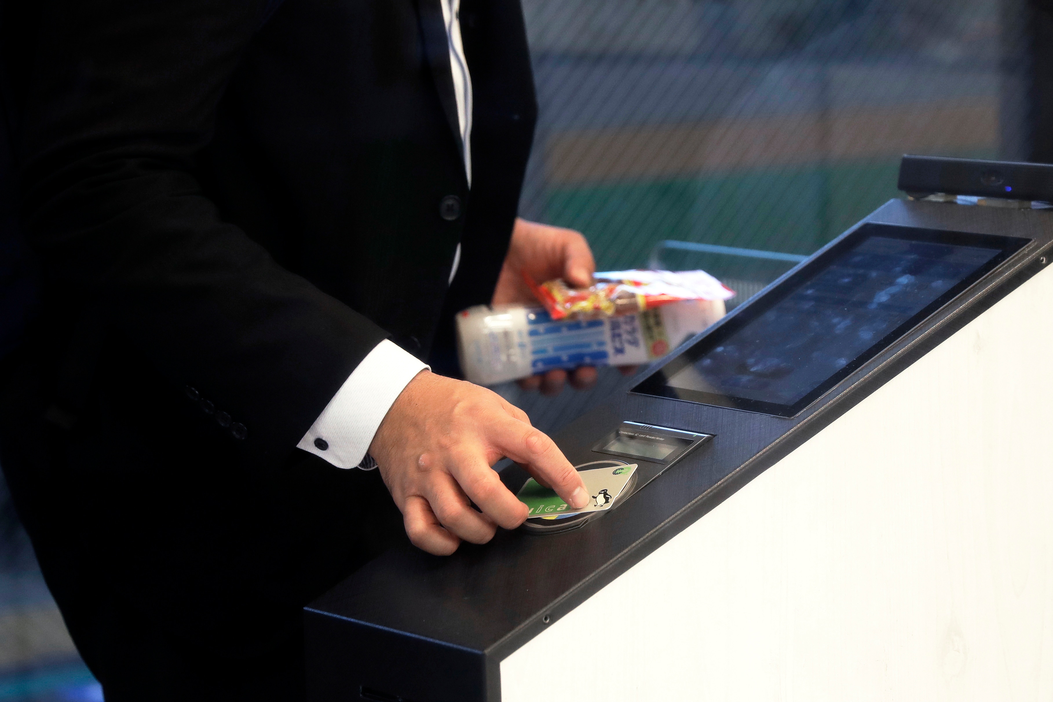 A customer uses a Suica pass at a cashierless kiosk.Photographer: Kiyoshi Ota/Bloomberg