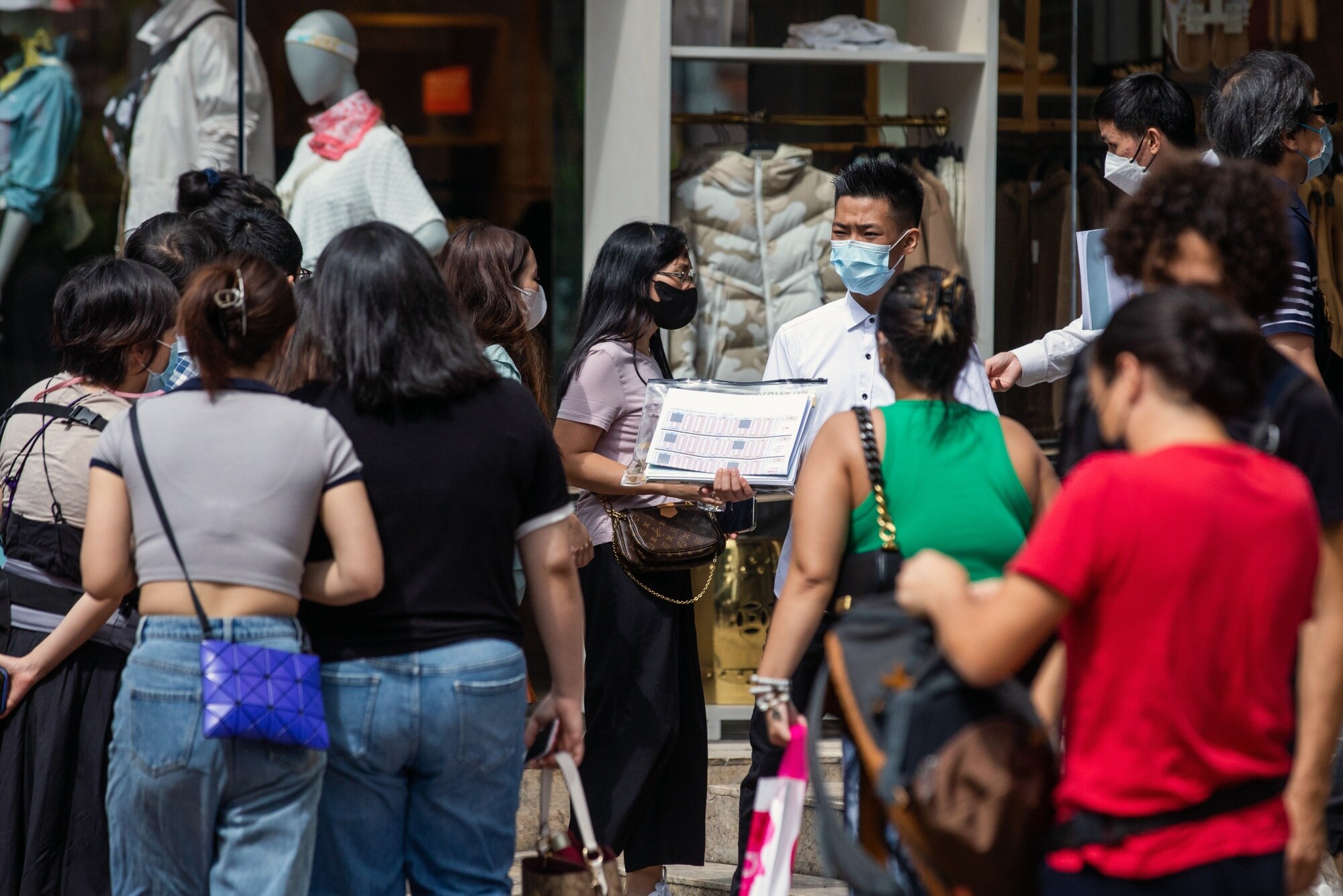 Real estate agents distribute leaflets for the One Innovale - Bellevue residential project in Hong Kong on Oct. 1.Photographer: Paul Yeung/Bloomberg
