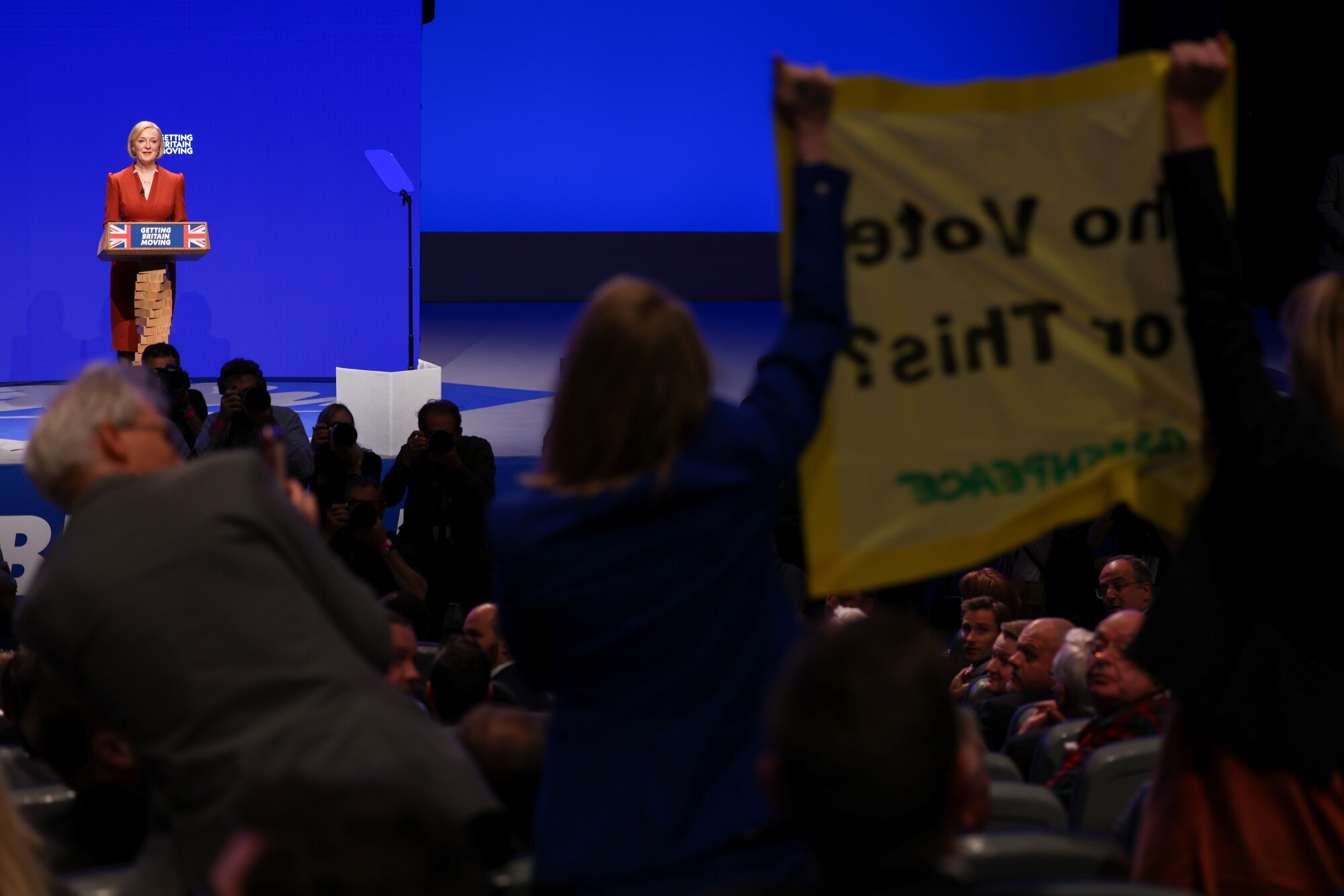 Liz Truss pauses as her keynote speech is interrupted by Greenpeace protesters, in Birmingham, UK, on Oct. 5.Photographer: Hollie Adams/Bloomberg