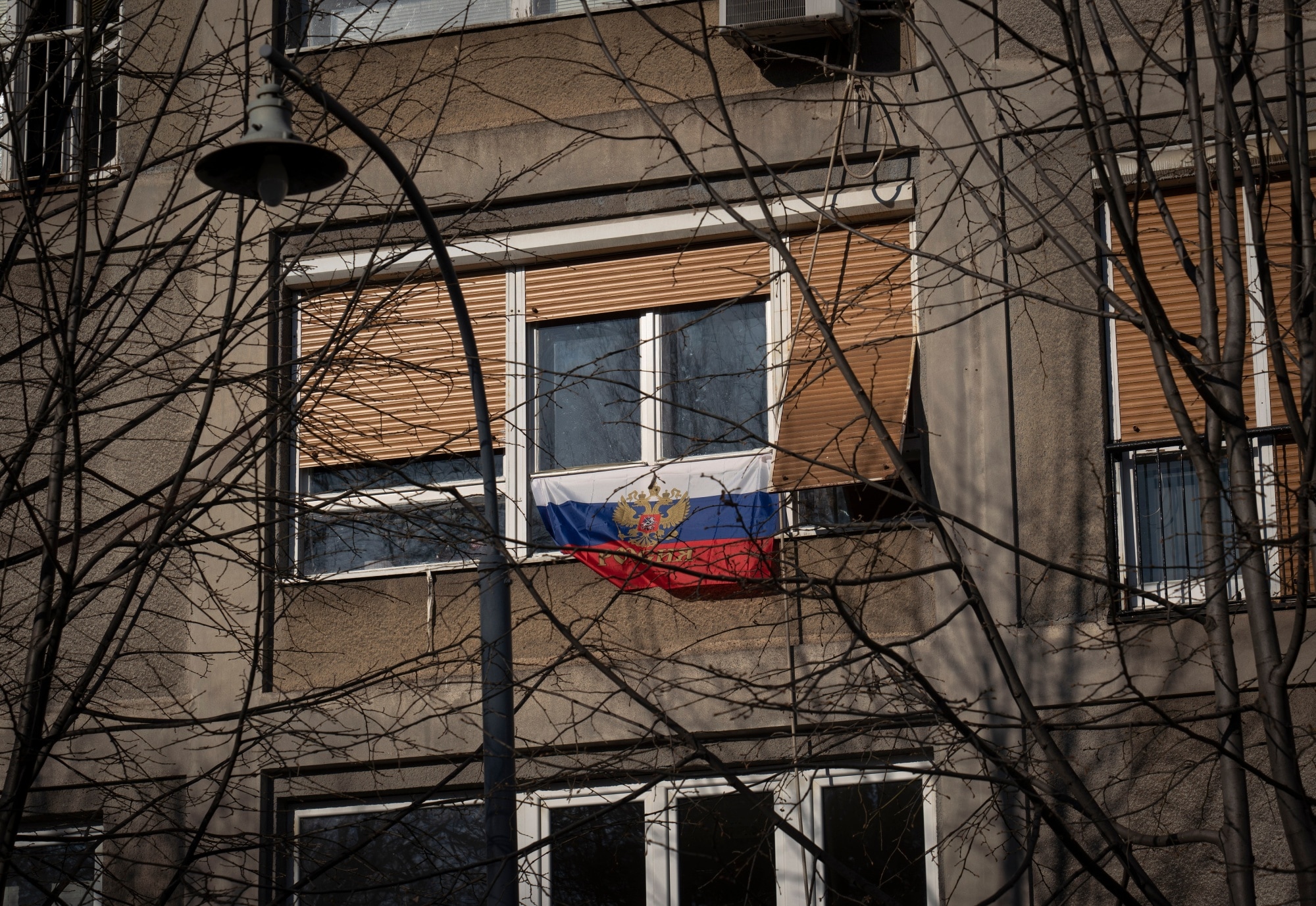 A Russian national flag hangs from the window of an apartment in Belgrade a month after the invasion of Ukraine.Photographer: Oliver Bunic/Bloomberg
