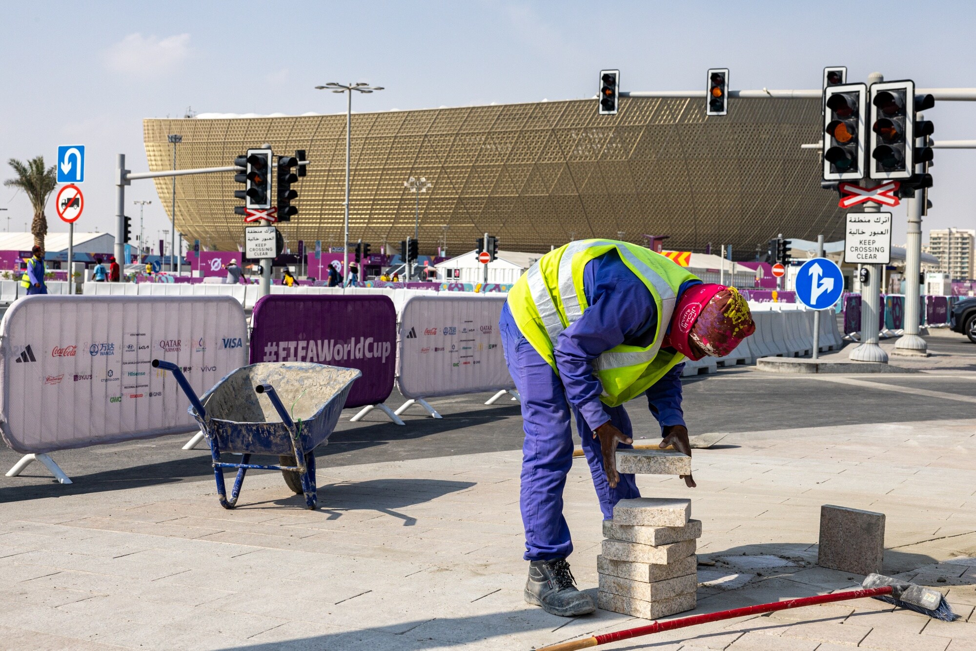 A labourer works outside Lusail Stadium in Doha in Nov.Photographer: Christopher Pike/Bloomberg