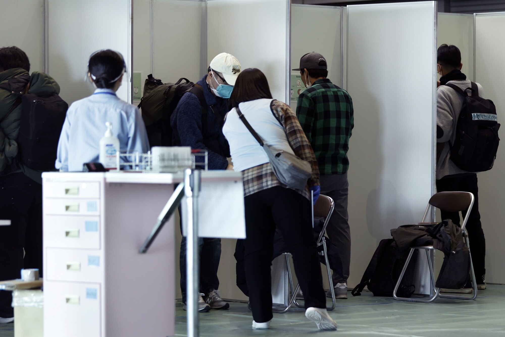 Arriving travelers from Shanghai, China, are tested for Covid-19 at Narita International Airport in Japan, on Dec. 3.Photographer: Kiyoshi Ota/Bloomberg