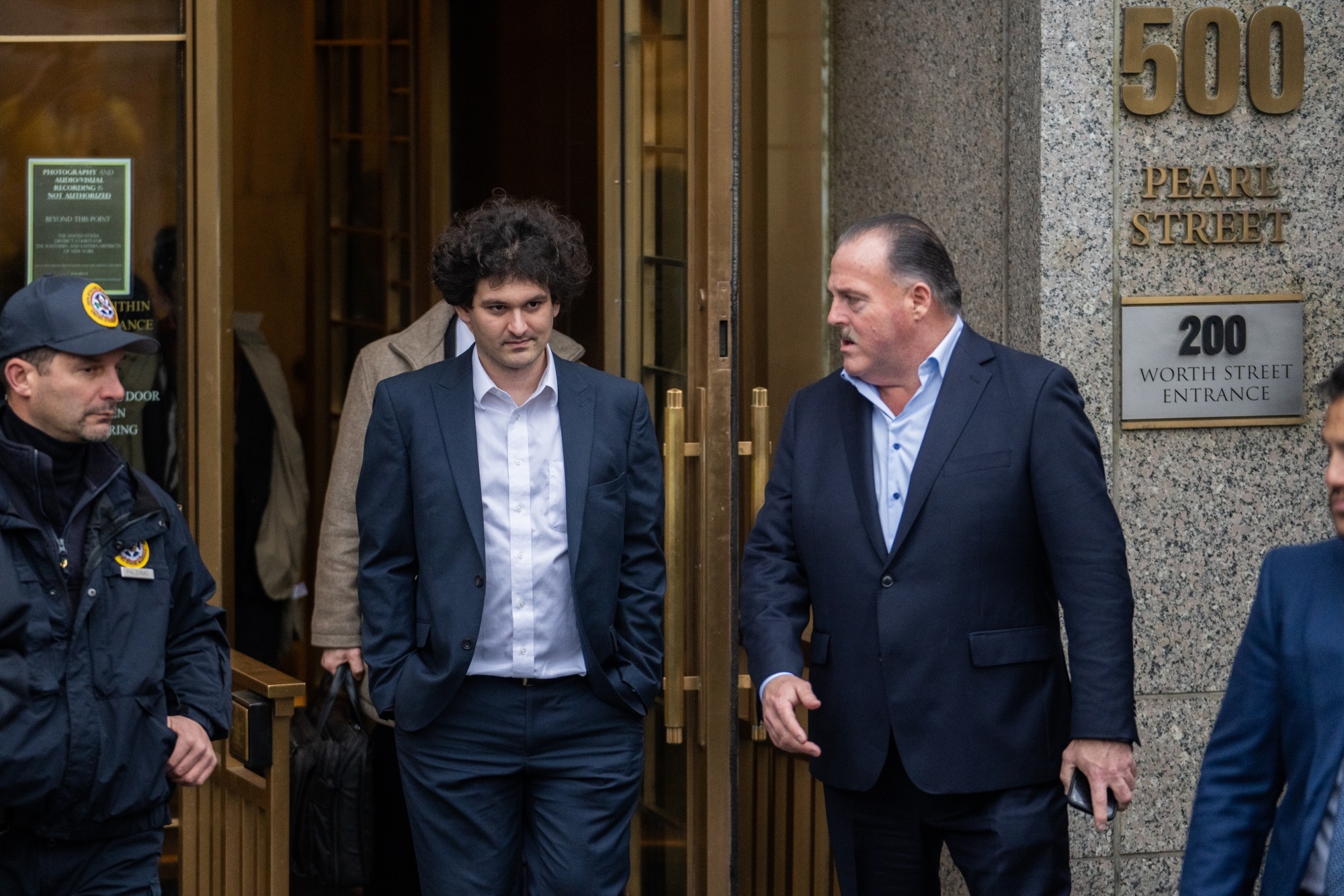 Sam Bankman-Fried, center, departs court in New York on Jan. 3.Photographer: Jeenah Moon/Bloomberg