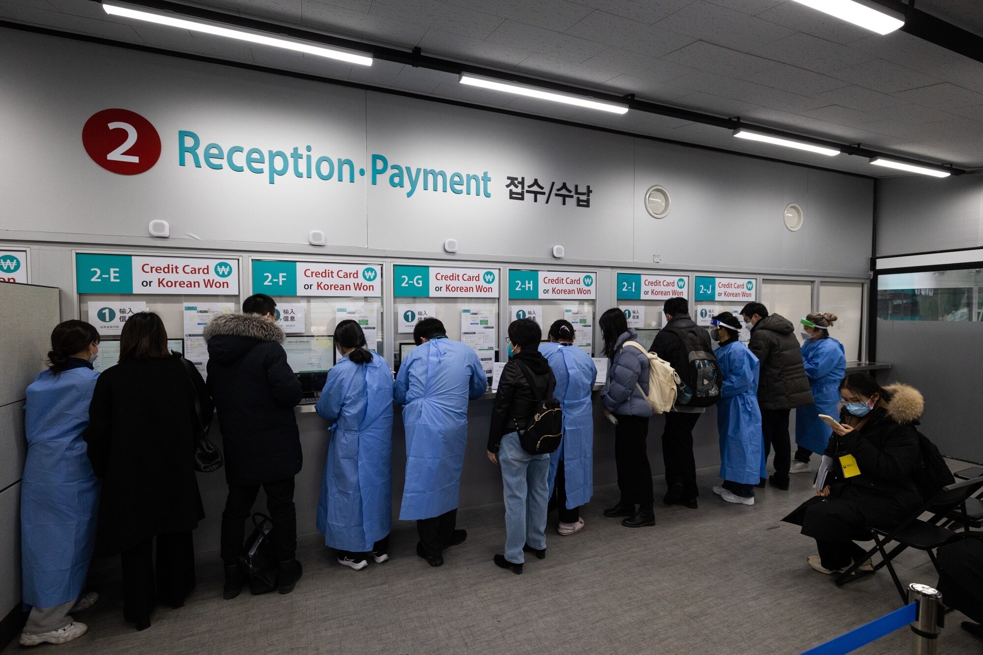 Healthcare workers assist travelers arriving from China inside a Covid-19 testing center at Incheon International Airport in South Korea on Jan. 6.Photographer: SeongJoon Cho/Bloomberg