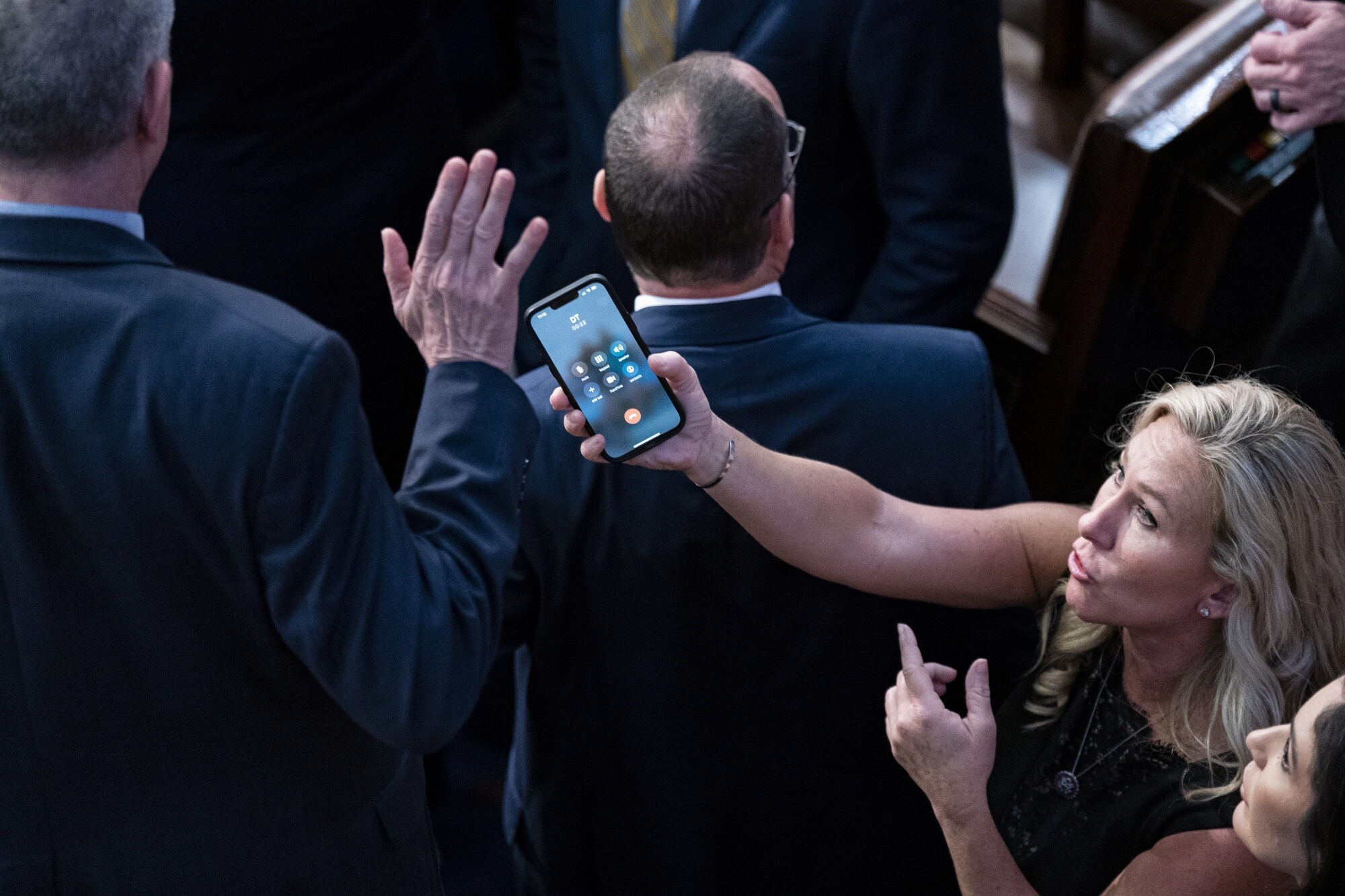 Marjorie Taylor Greene holds her smart phone with Donald Trump on the line, to Matt Rosendale.Photographer: Al Drago/Bloomberg