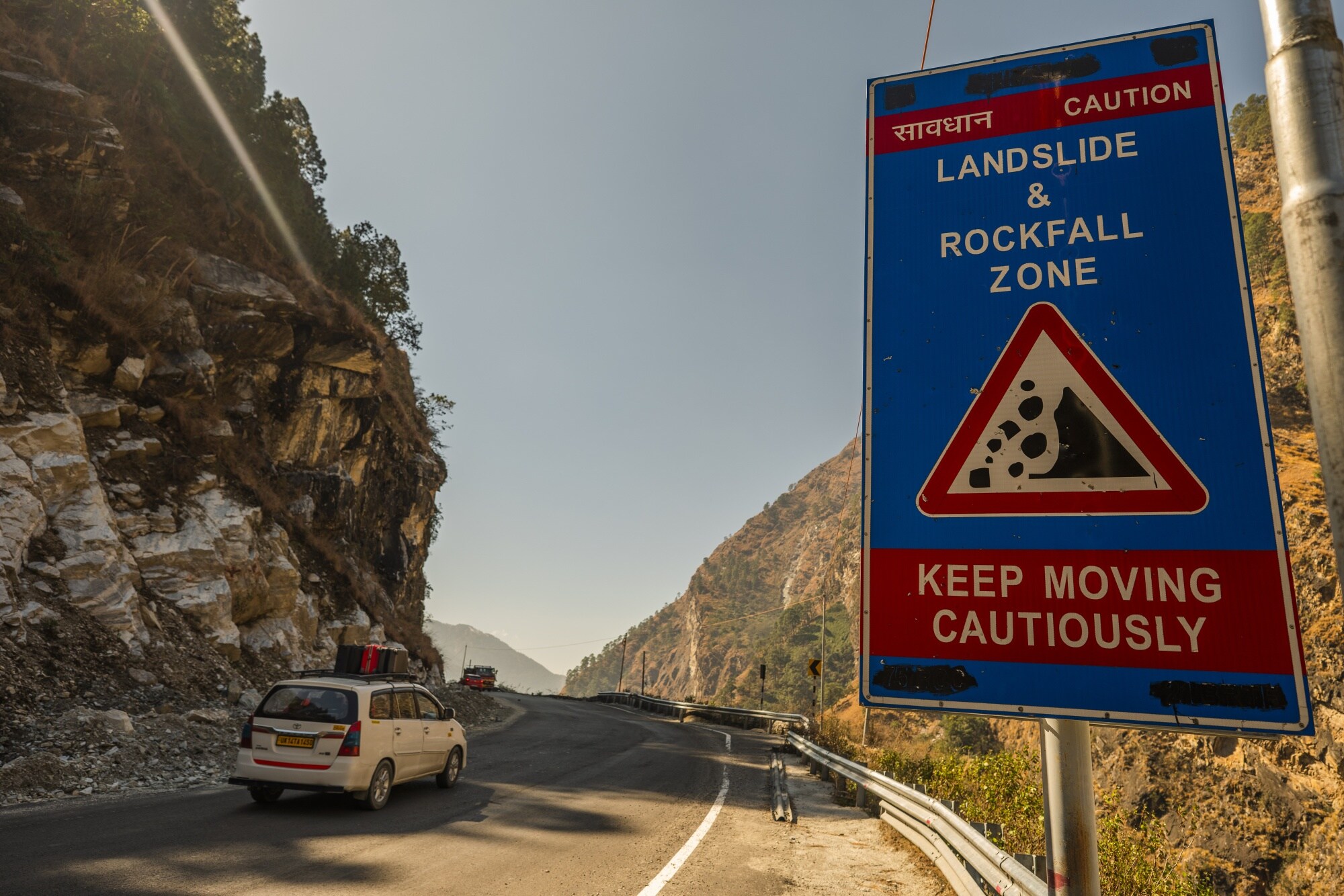 A caution sign for a landslide and rockfall zone posted along a road in Joshimath in Feb. 2022.Photographer: Prashanth Vishwanathan/Bloomberg