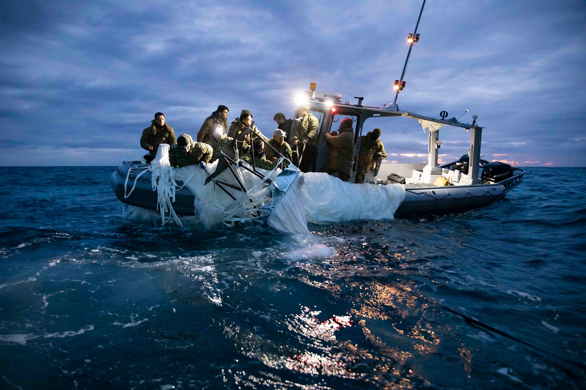 Sailors assigned to Explosive Ordnance Disposal Group 2 recover the high-altitude surveillance balloon off the coast of Myrtle Beach, South Carolina on Feb. 5.Photographer: Petty Officer 1st Class Tyler Thompson/US Navy