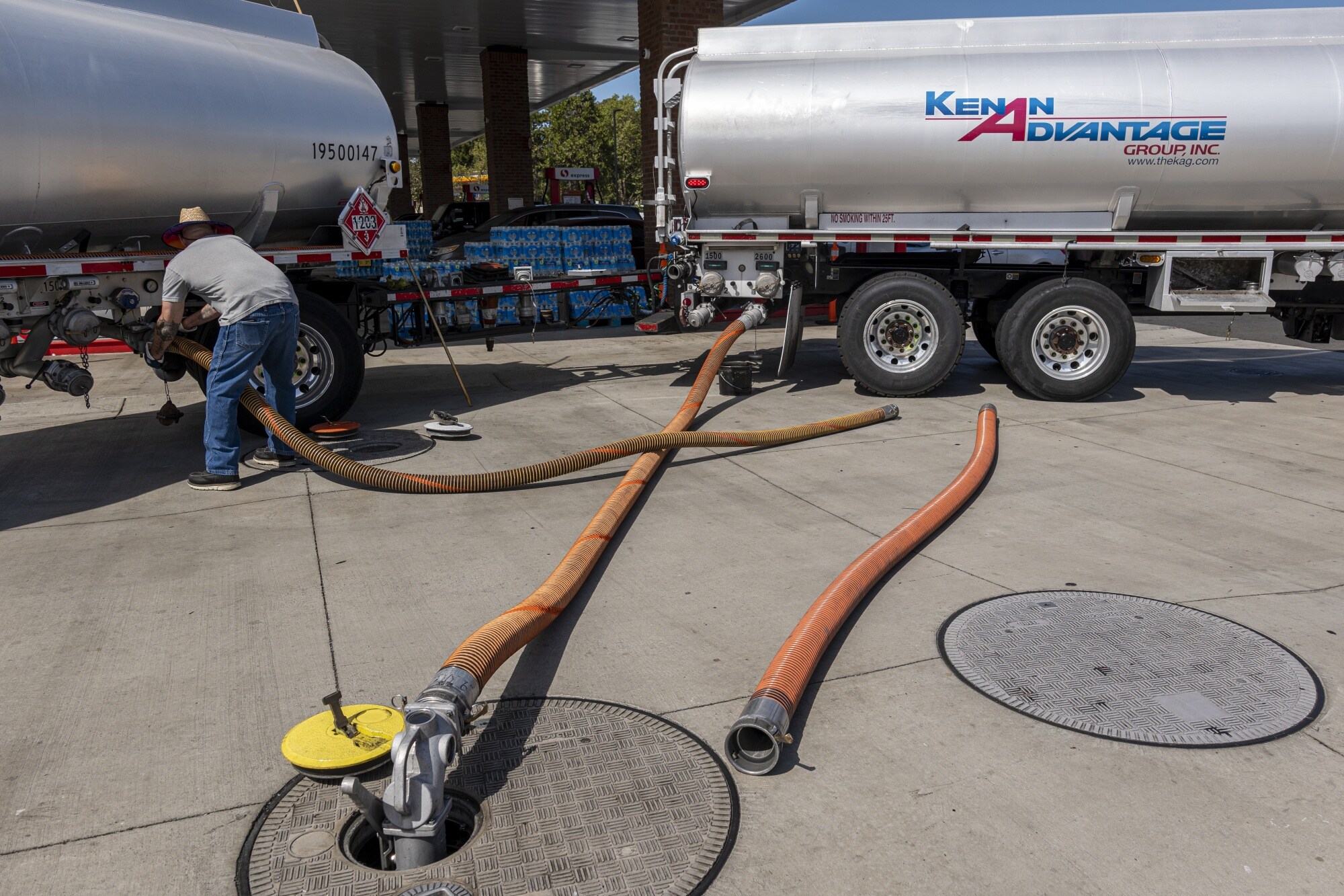 A fuel distributor prepares a fuel refill at a gas station in California.Photographer: David Paul Morris/Bloomberg