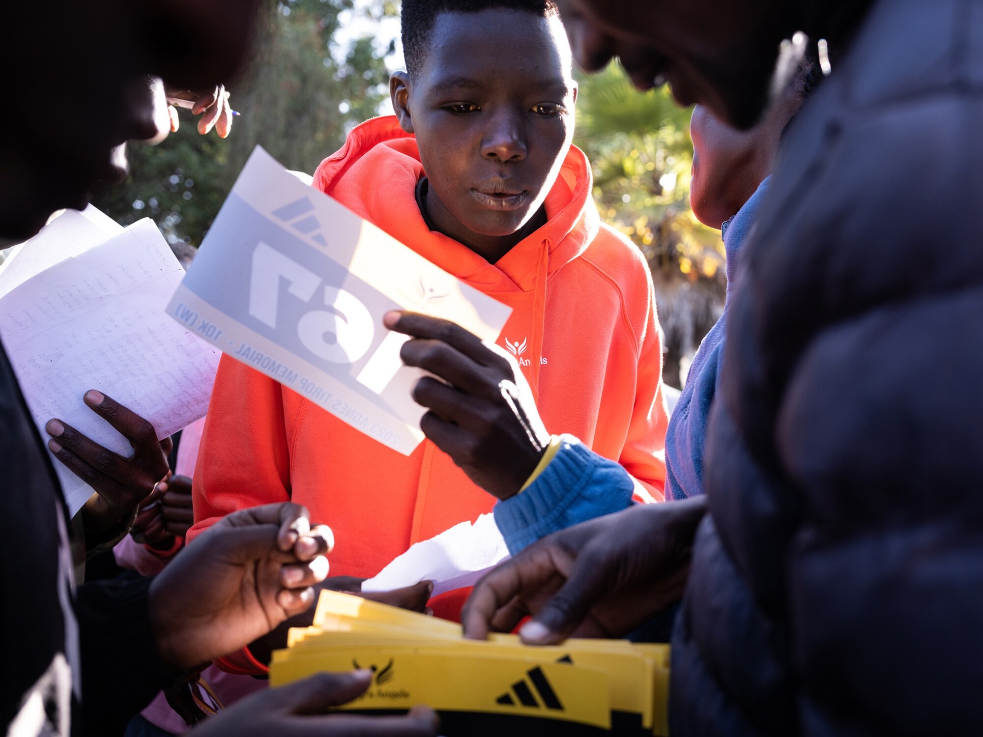 Eve Tirop collecting her number for the memorial race honoring her sister. It was her first race, which she says she ran to sustain Agnes's legacy. Photographer: Nichole Sobecki/Bloomberg