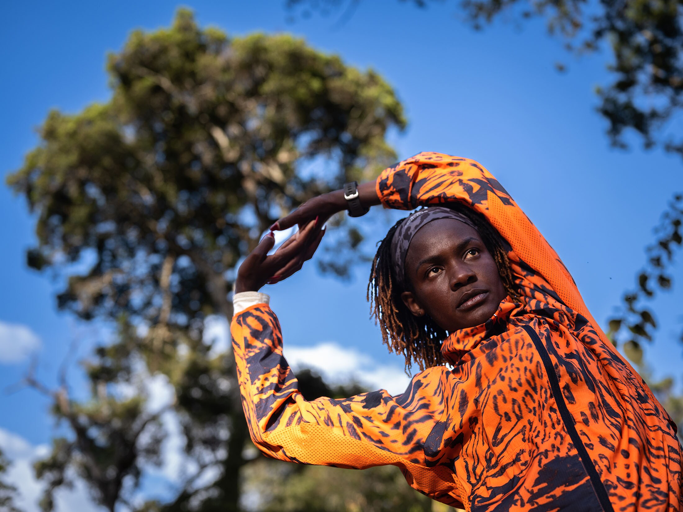 Joan Chelimo stretches after a training run in Iten. The fifth-place finisher in last year's London Marathon is a co-founder of Tirop's Angels, a group formed to stop gender-based violence. Photographer: Nichole Sobecki/Bloomberg