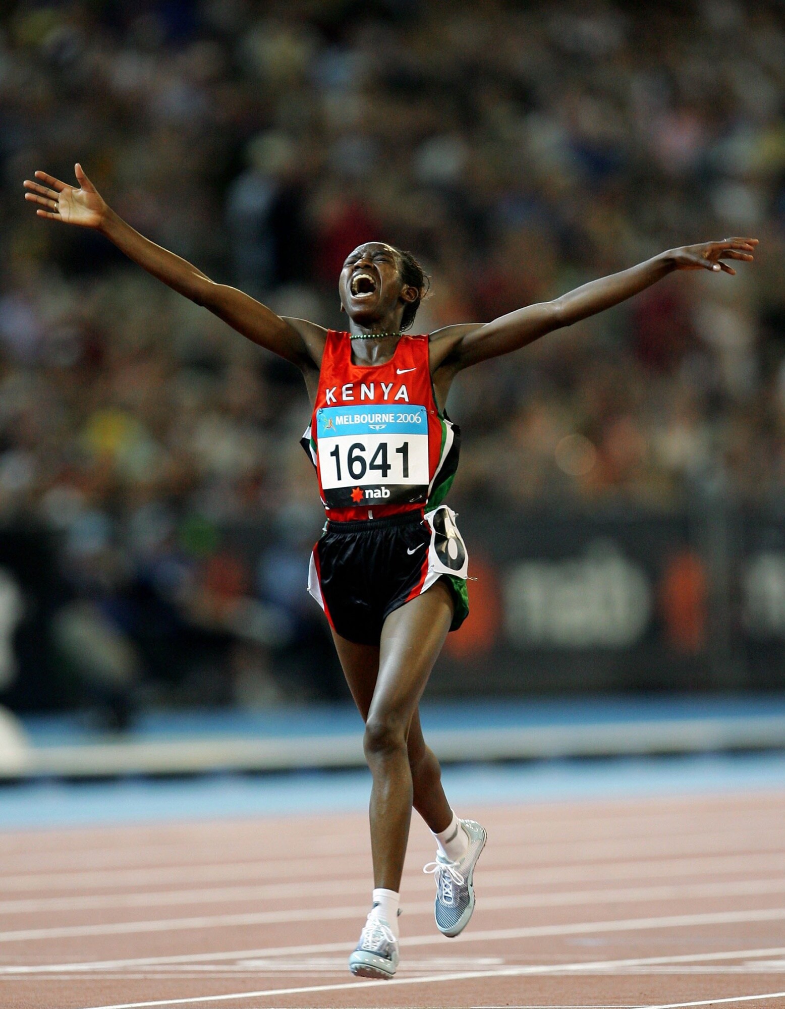 Lucy Kabuu celebrates winning the women's 10,000-meter race at the 2006 Commonwealth Games in Melbourne. Photographer: Mike Hewitt/Getty Images