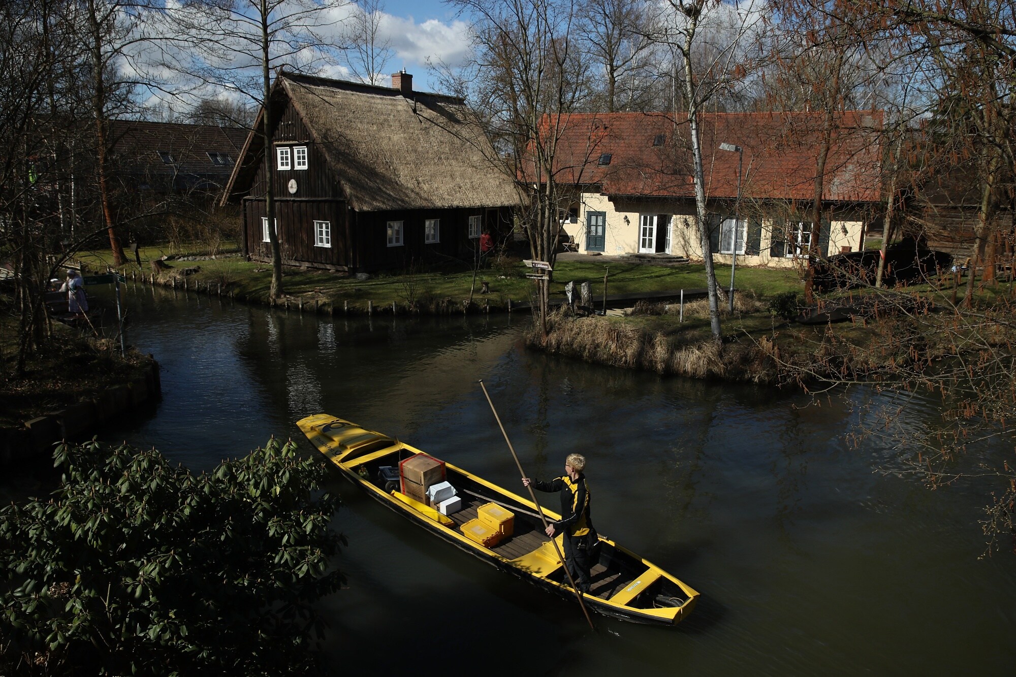 A postal worker delivers mail by canoe in Luebbenau, in the Spreewald region.Photographer: Sean Gallup/Getty Images