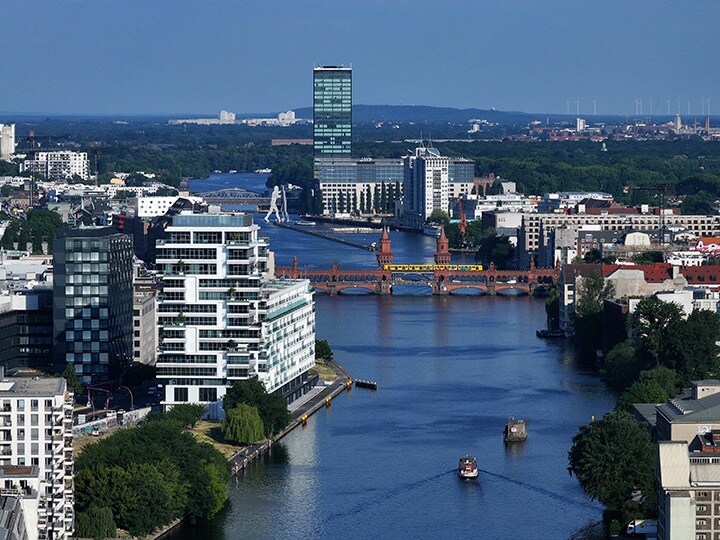 A train passes over Oberbaumbrücke bridge on the Spree River in Berlin. Photographer: Sean Gallup/Getty Images