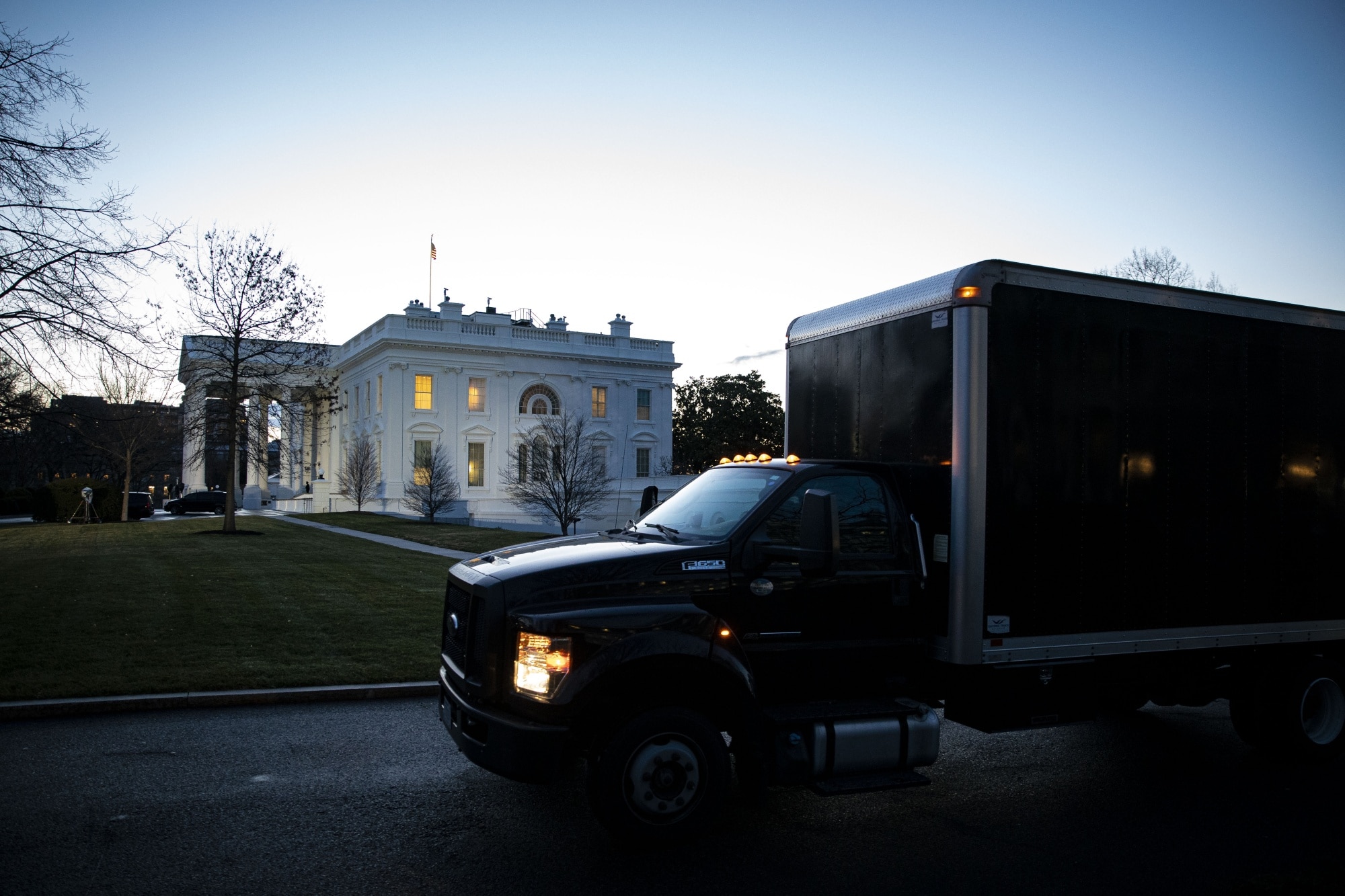 A moving truck departs the West Wing of the White House at dawn on Jan. 20, 2021.Photographer: Al Drago/Bloomberg